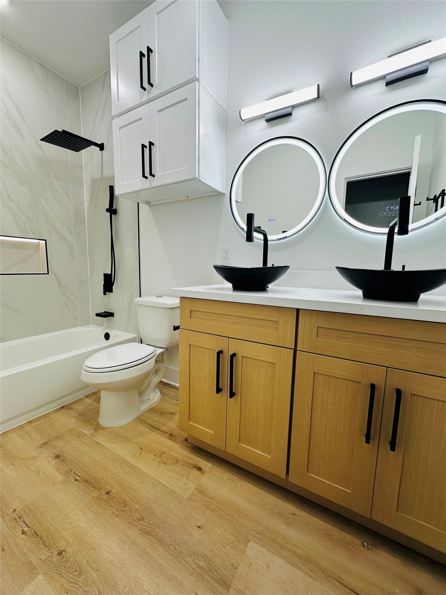 bathrooms feature 4ft x 9ft porecilan tile wall slabs, push button toilets, matte black hardware, matte black pull out multi function vanity faucets, multi color led mirros, double stacked head knocker cabinets, illuminated soap niches, upgraded shower faucets with hand held sprayer, and more.