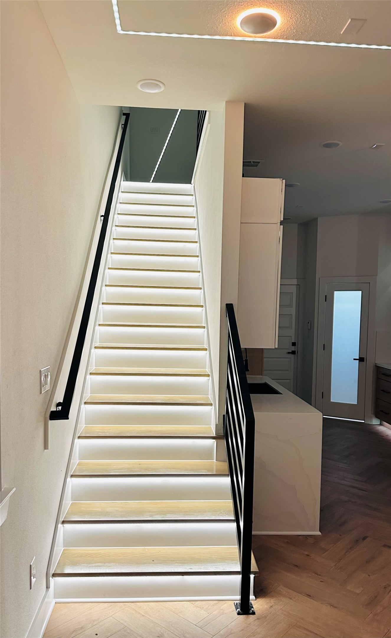 LED illuminated stairs in unit A & B only. All stairs feature custom made wrought iron stai rails and ballusters