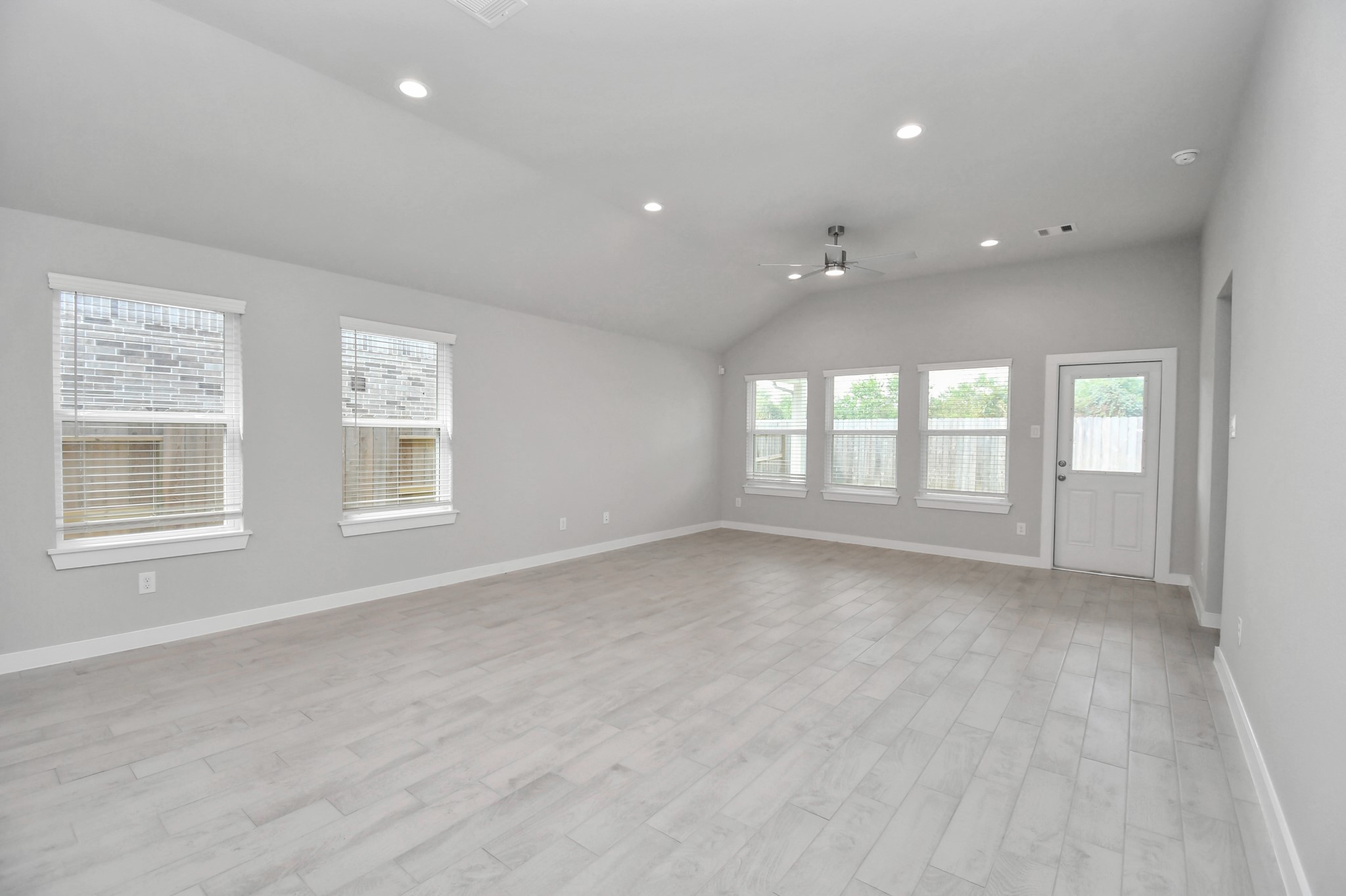 Gather the family and guests together in your lovely living room! Featuring soaring high ceilings, recessed lighting, ceiling fan, custom paint, gorgeous floors, and large windows that provide plenty of natural lighting throughout the day. Sample photo of completed home with similar floor plan. Actual colors and selections may vary.
