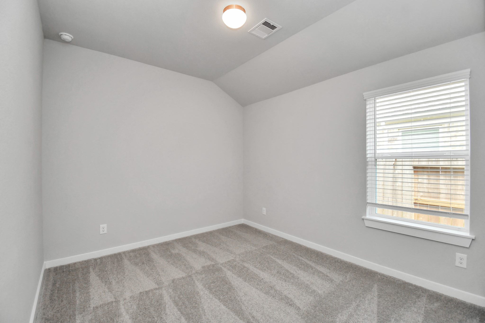 Secondary bedroom features plush carpeting, large windows that let in plenty of natural light, bright paint, and spacious closets. Sample photo of completed home with similar floor plan. Actual colors and selections may vary.
