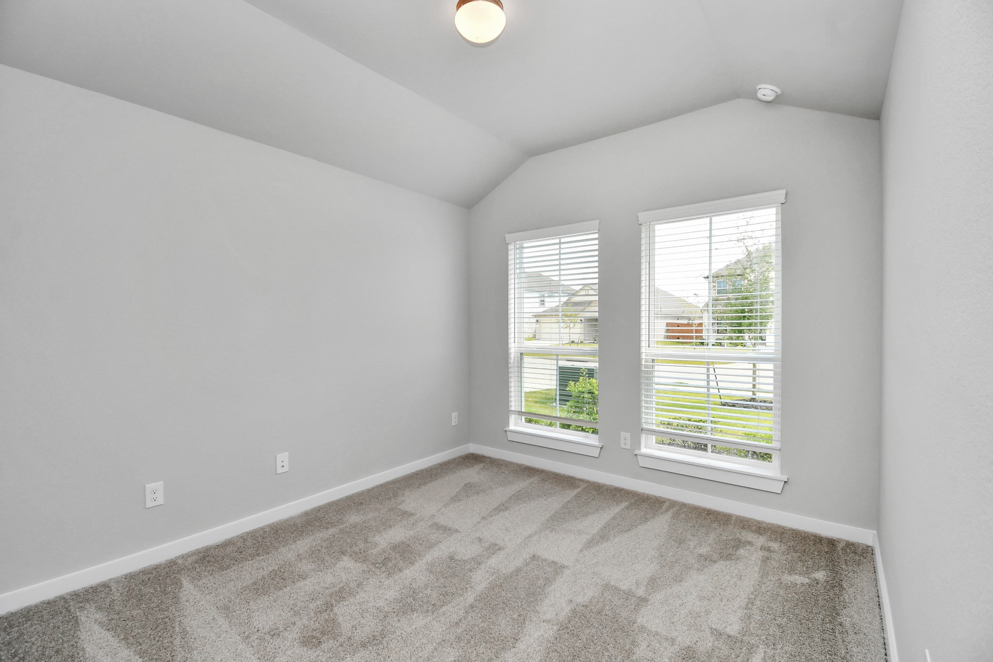 Generously sized secondary bedrooms featuring spacious closets, soft and inviting carpeting underfoot, large windows allowing plenty of natural light, and the added touch of privacy blinds for your personal retreat. Sample photo of completed home with similar floor plan. Actual colors and selections may vary.