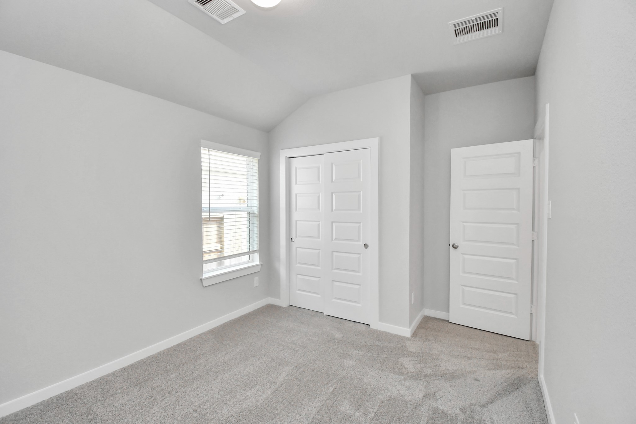 Generously sized secondary bedrooms featuring spacious closets, soft and inviting carpeting underfoot, large windows allowing plenty of natural light, and the added touch of privacy blinds for your personal retreat. Sample photo of completed home with similar floor plan. Actual colors and selections may vary.
