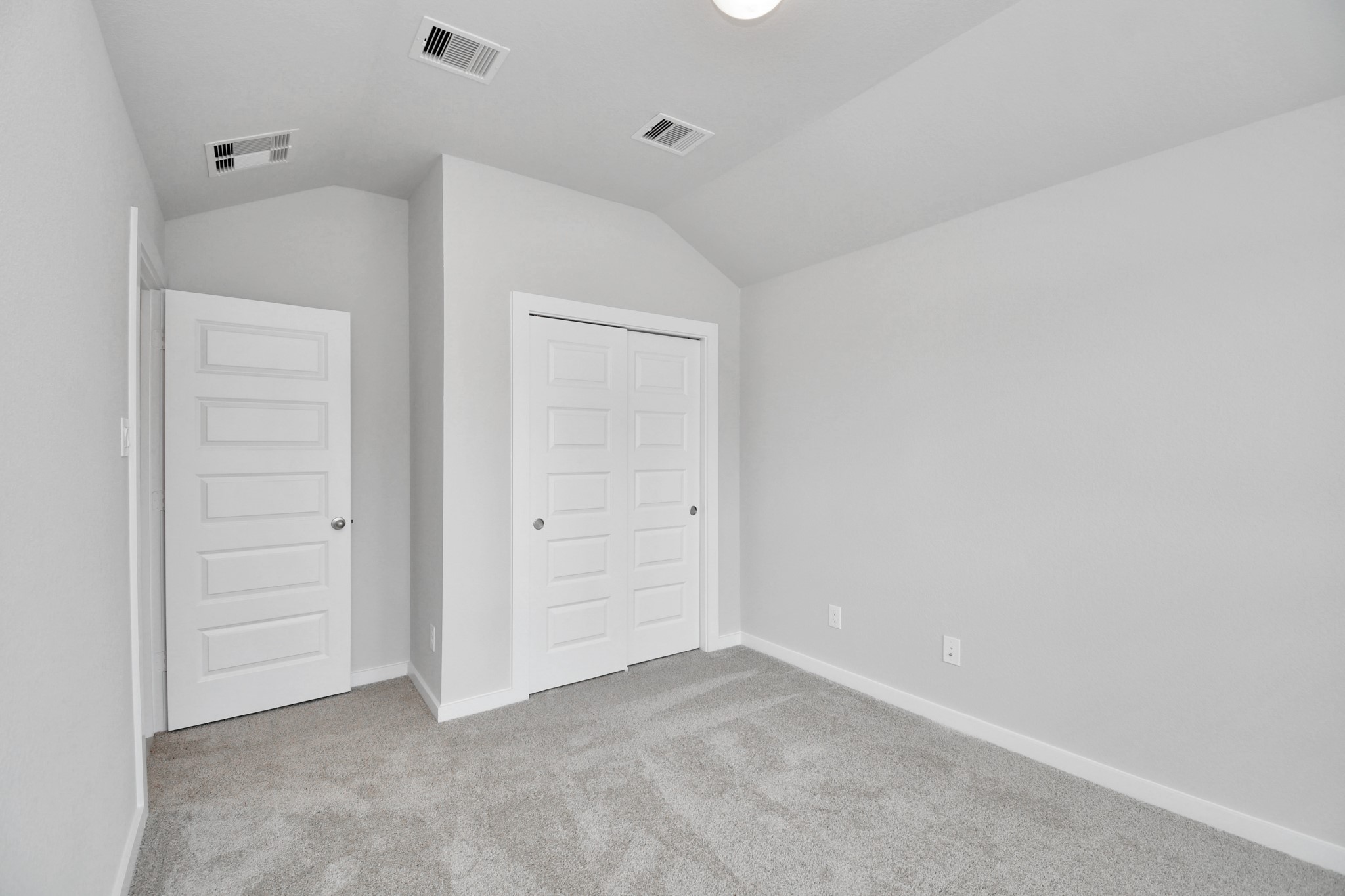 Secondary bedroom features plush carpeting, large windows that let in plenty of natural light, bright paint, and spacious closets. Sample photo of completed home with similar floor plan. Actual colors and selections may vary.
