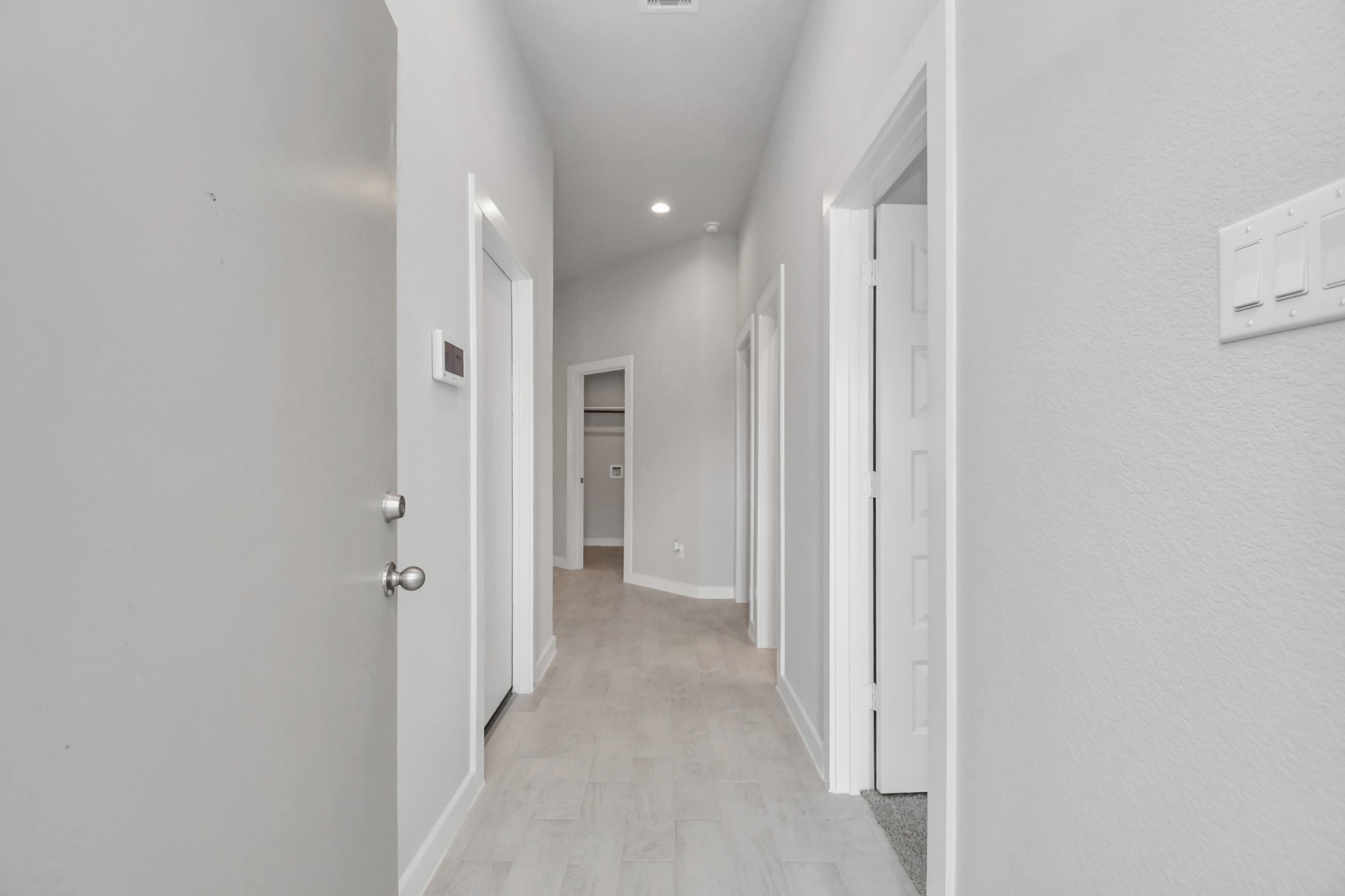 As you step into the threshold of this luxurious home, you'll soon be welcomed by an elegant glass door (to be installed). Inside, soaring ceilings amplify the spaciousness, while the refined wood-look tile flooring and oversized baseboards exude sophistication and charm. Sample photo of completed home with similar floor plan. Actual colors and selections may vary.