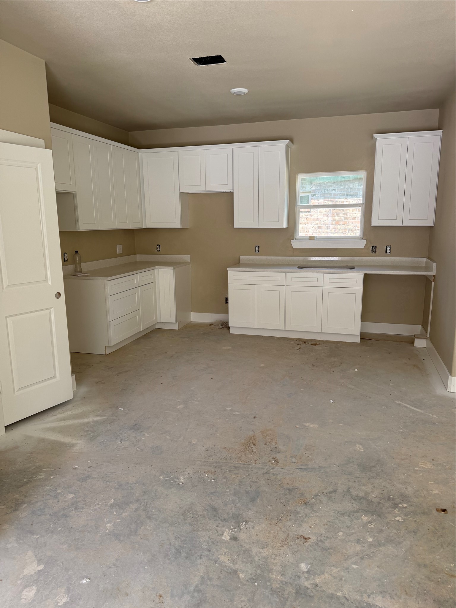 White shaker cabinets with quartz countertops and stainless steel appliances