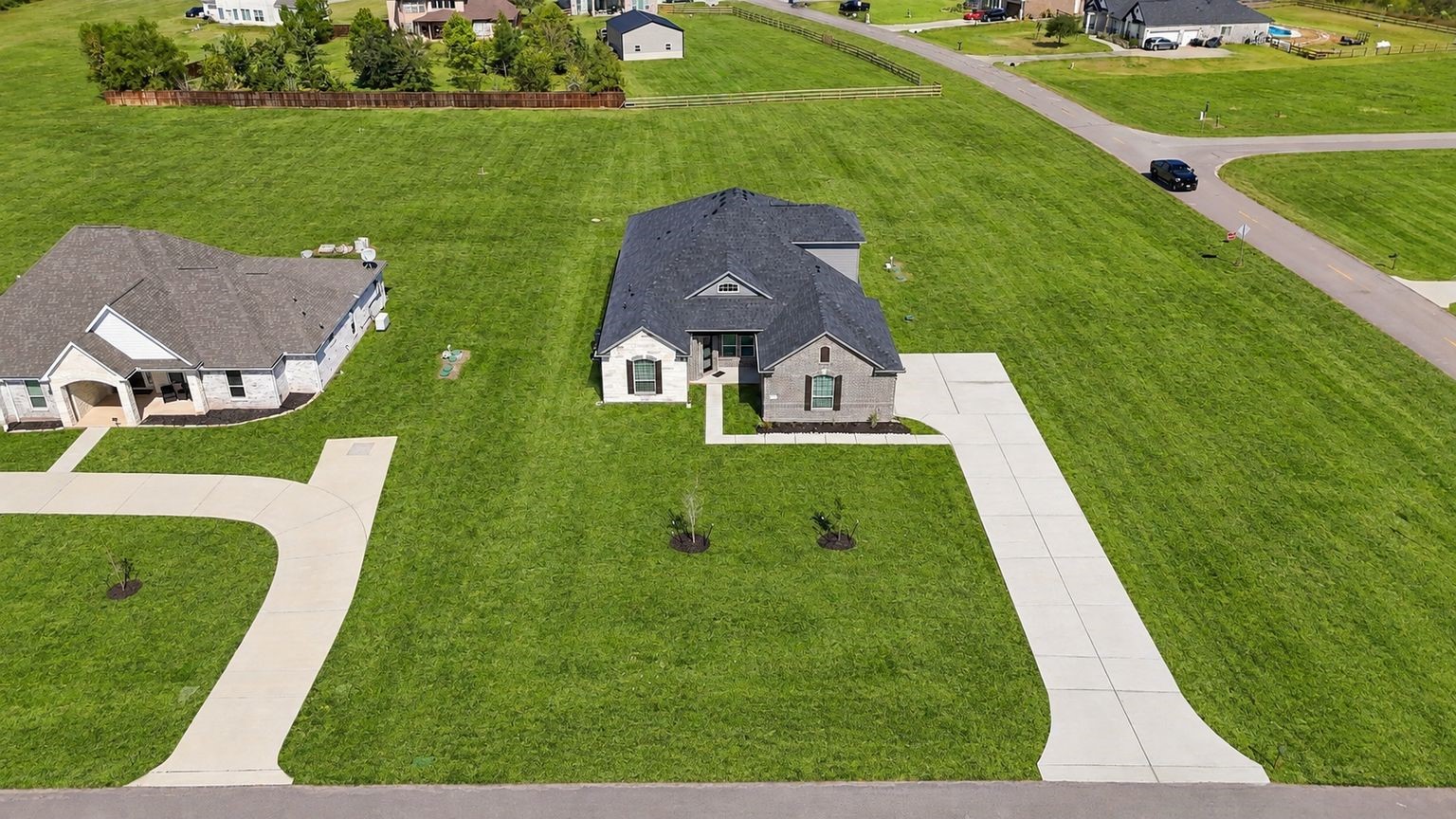 SPACE, PRIVACY & ENDLESS POSSIBILITIES! A stunning aerial perspective showcases the home's attractive exterior, long driveway, and expansive lawn! Situated on approximately 1.163 ACRES, this property offers an exceptional amount of outdoor space and exciting possibilities for entertaining, recreation, and enjoying the outdoors!