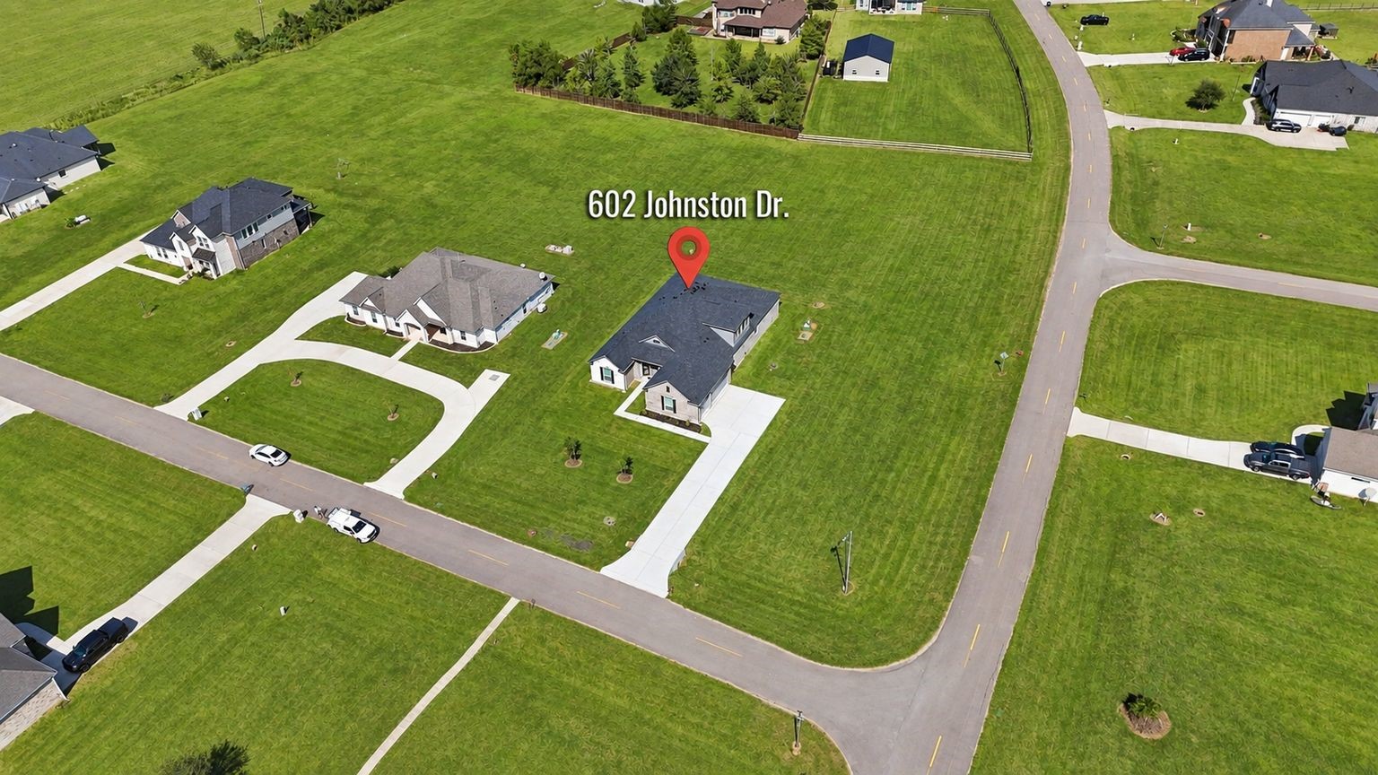 INCREDIBLE LOT WITH ROOM TO GROW! This aerial view highlights the property's generous footprint, corner positioning, and surrounding green space! With approximately 1.163 ACRES, there's plenty of room to enjoy outdoor living, gardening, recreation, and the freedom to create a personalized outdoor retreat!