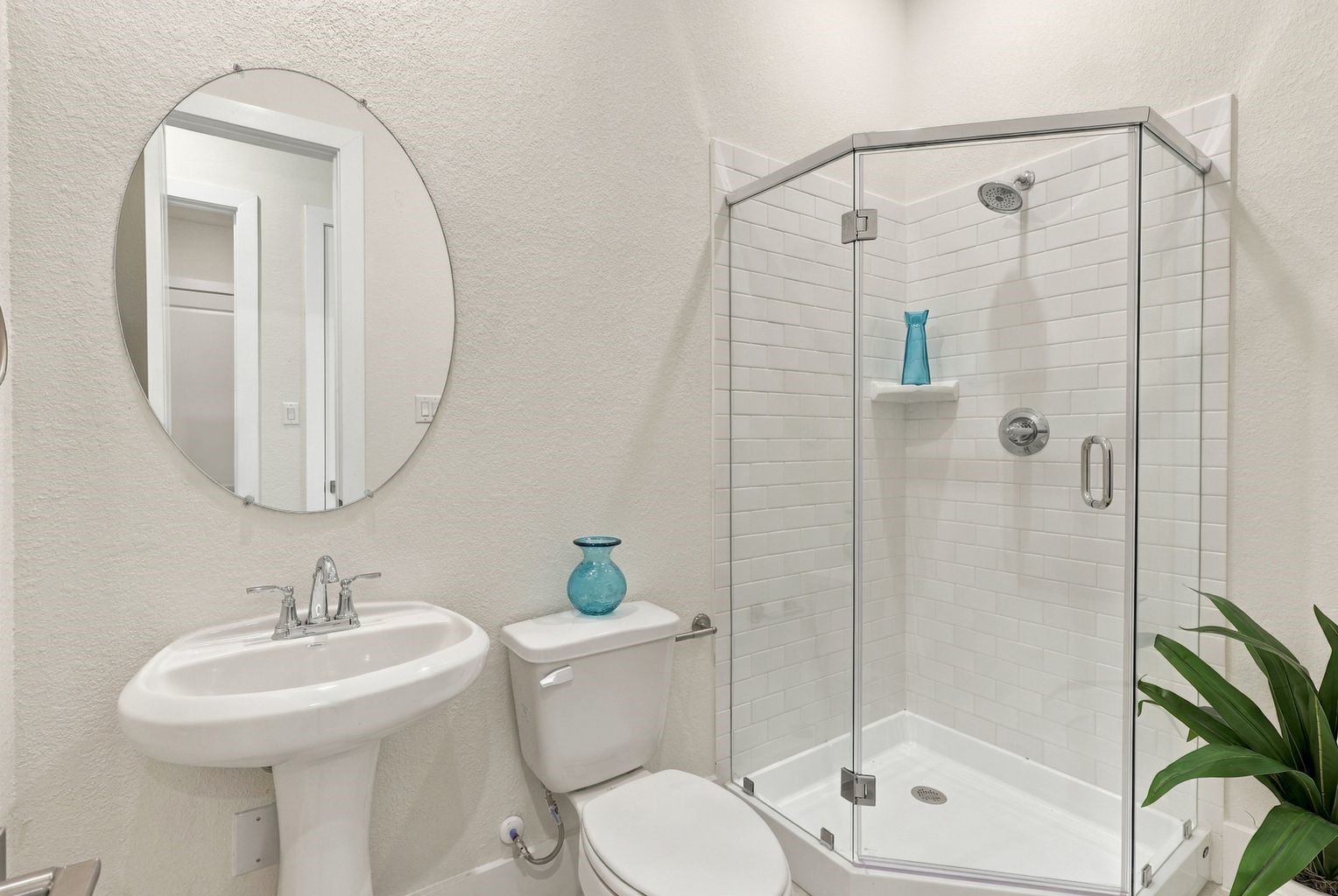 MODERN & REFRESHING BATHROOM! This STYLISH secondary bathroom features a pedestal sink, a glass-enclosed shower, contemporary fixtures, and a clean, neutral palette! A bright, functional space that combines everyday convenience with timeless appeal.