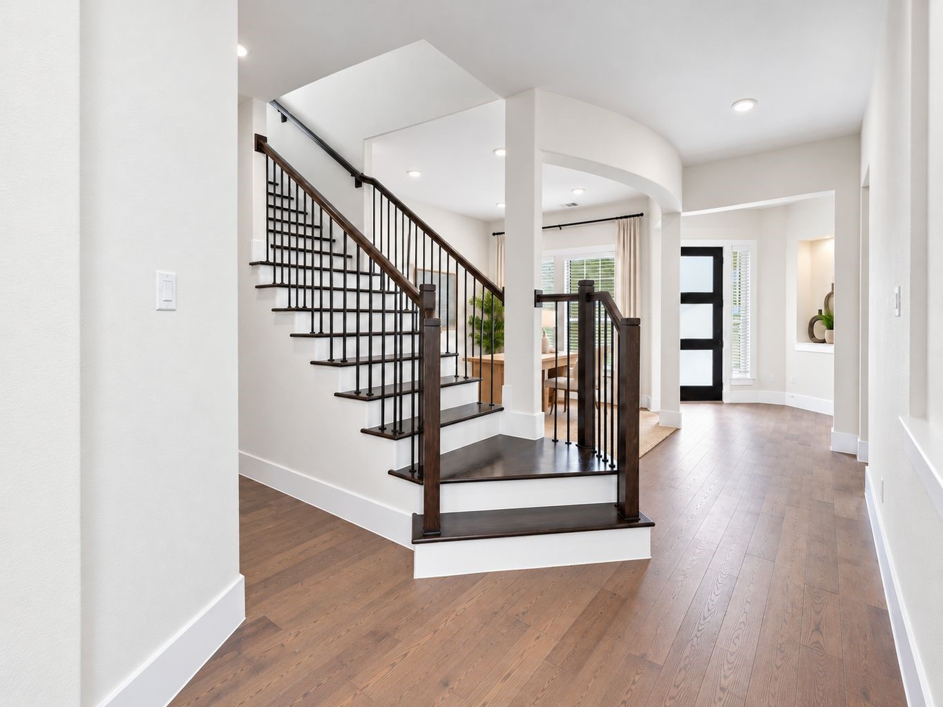 SHOWSTOPPING STAIRCASE & WELCOMING FOYER! Make a memorable first impression with this ELEGANT entry featuring a striking staircase with dark railings, high ceilings, and gorgeous engineered wood flooring throughout the main living areas! The open layout creates a seamless connection between the foyer and adjoining living spaces! **Photo is Virtually Staged** SHOWSTOPPING STAIRCASE & WELCOMING FOYER! Make a memorable first impression with this ELEGANT entry featuring a striking staircase with dark railings, high ceilings, and gorgeous engineered wood flooring throughout the main living areas! The open layout creates a seamless connection between the foyer and adjoining living spaces! **Photo is Virtually Staged**