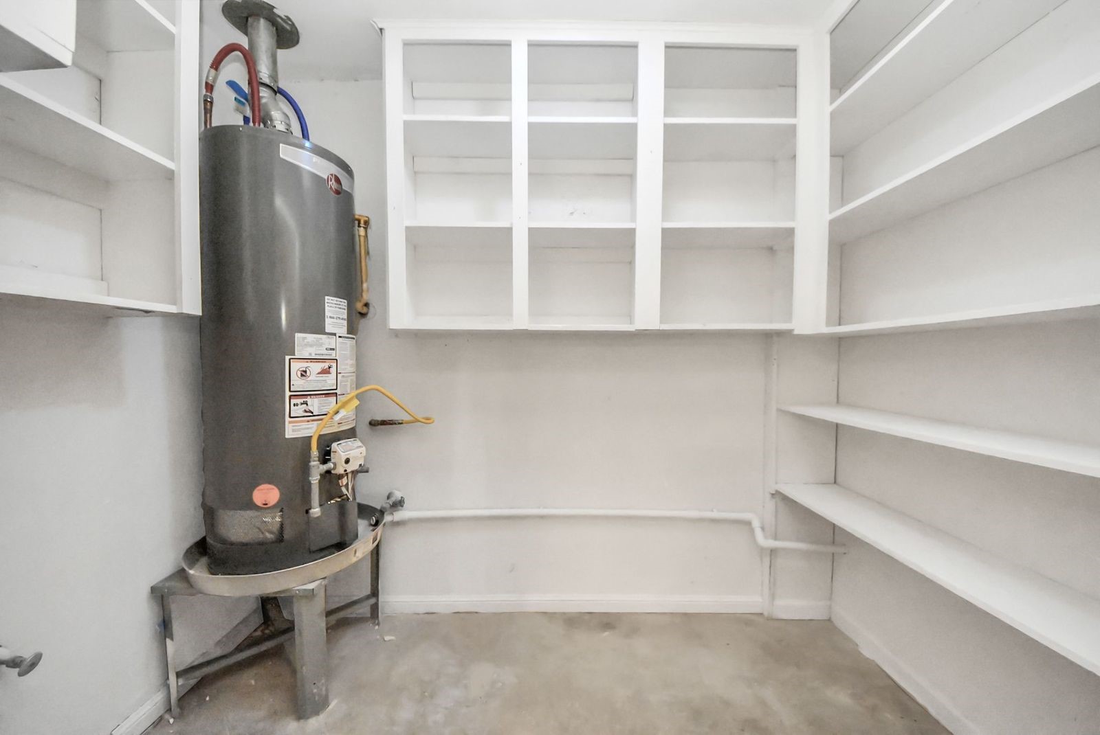 Work/storage area with the water heater and it's own sink.