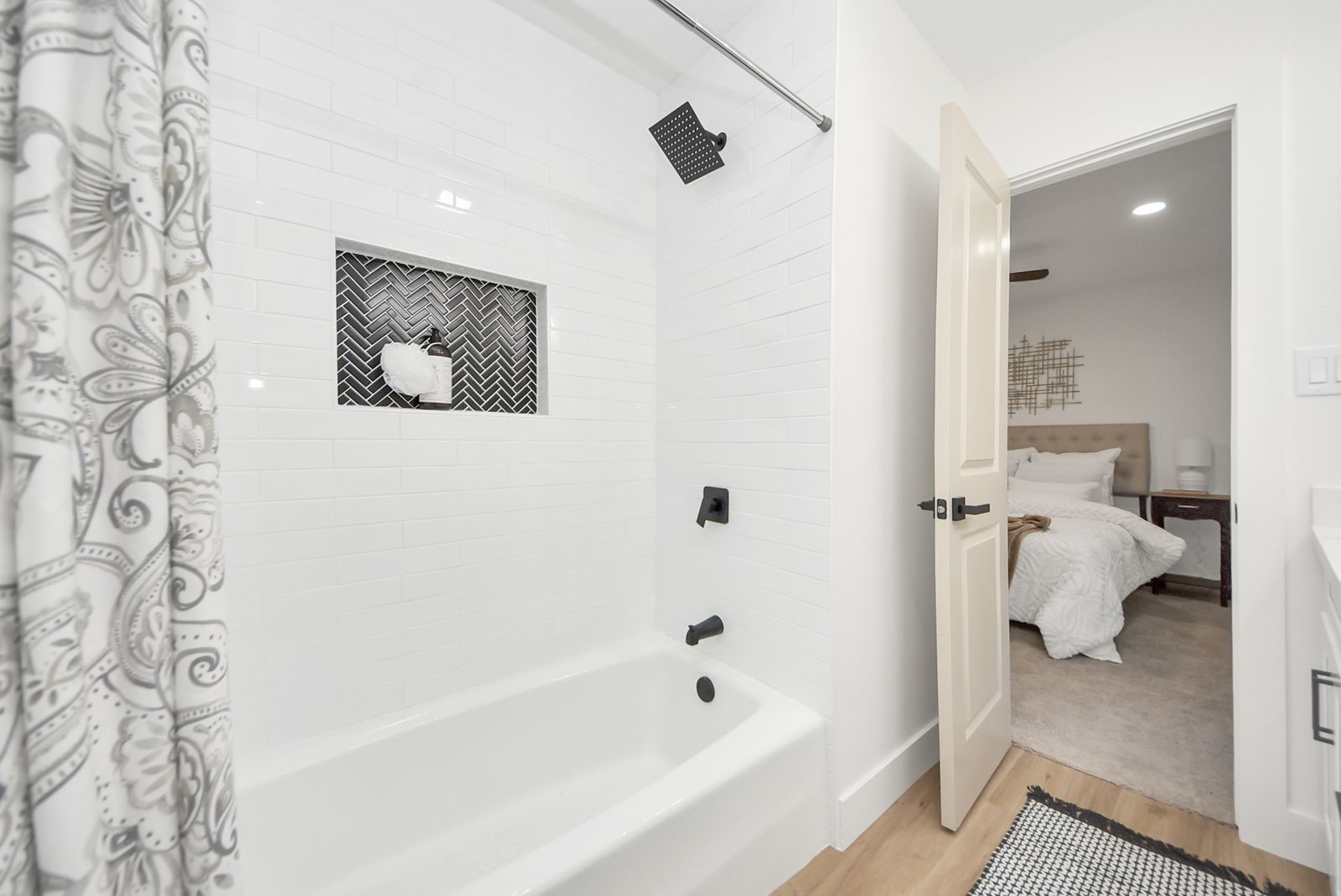 Shower niche with accented herringbone black tile.