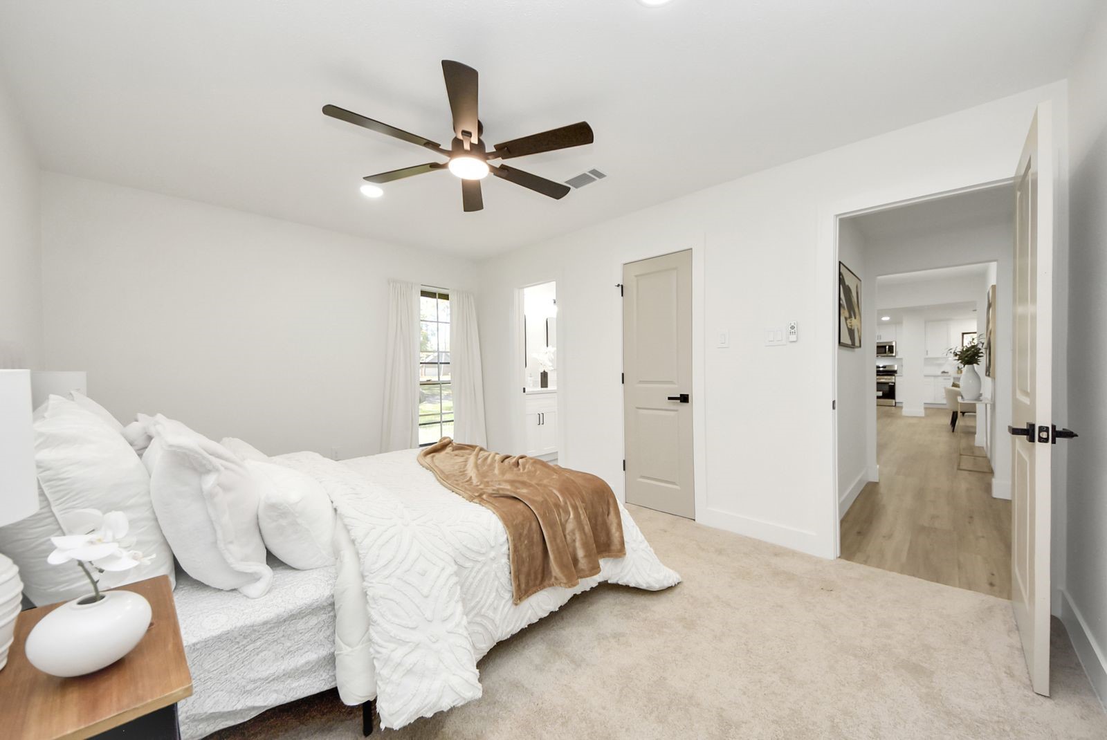 Primary bedroom with view into living area.