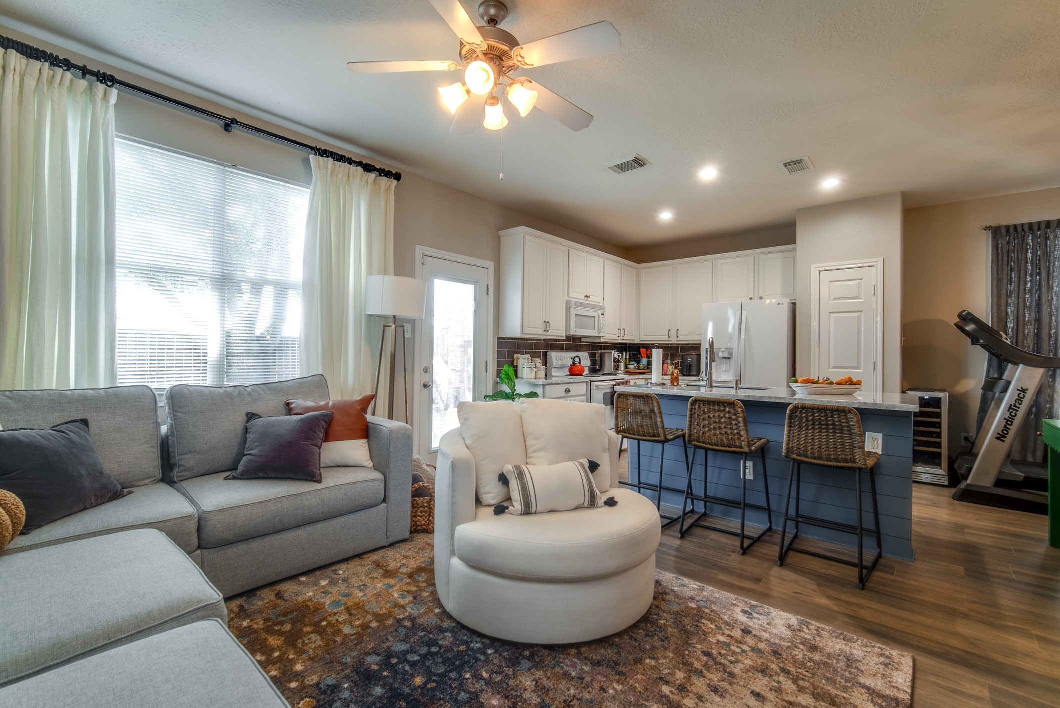 Living room with updated flooring and tons of natural light