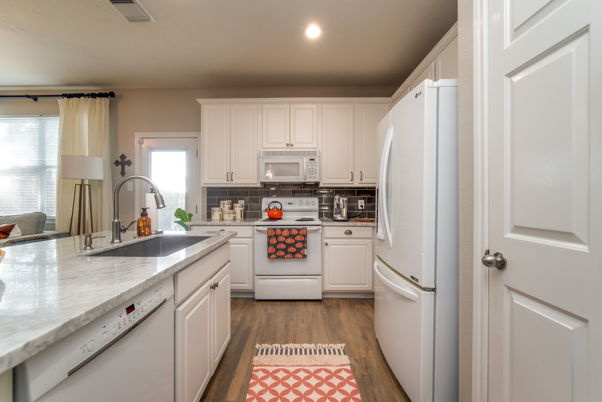 Spacious kitchen with tons of counter space and cabinet space.  Pantry is through the door on the right side