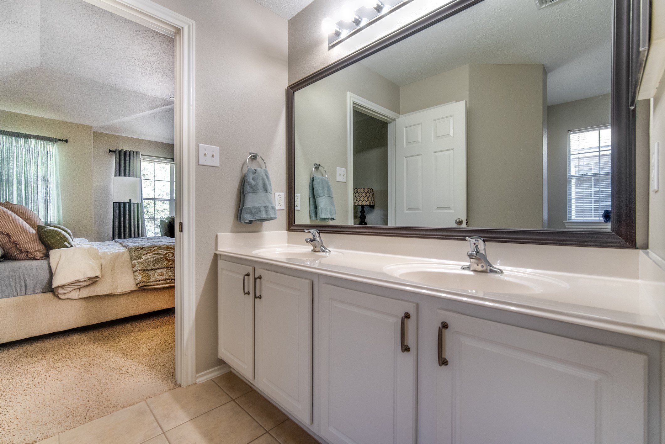 Primary bathroom offers double sinks and soaking tub with separate shower