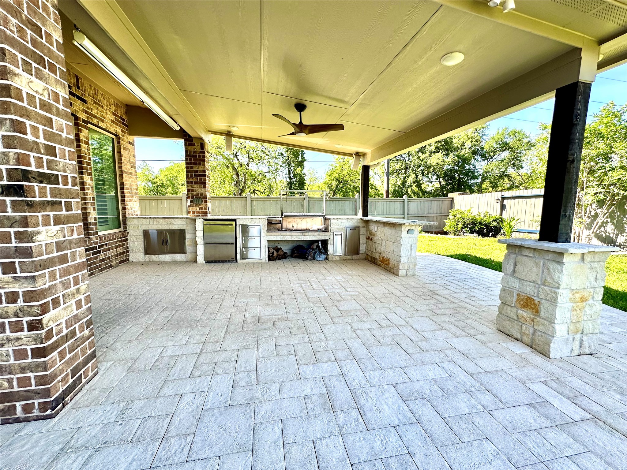 Covered patio in backyard with elegant outdoor kitchen Covered patio in backyard with elegant outdoor kitchen