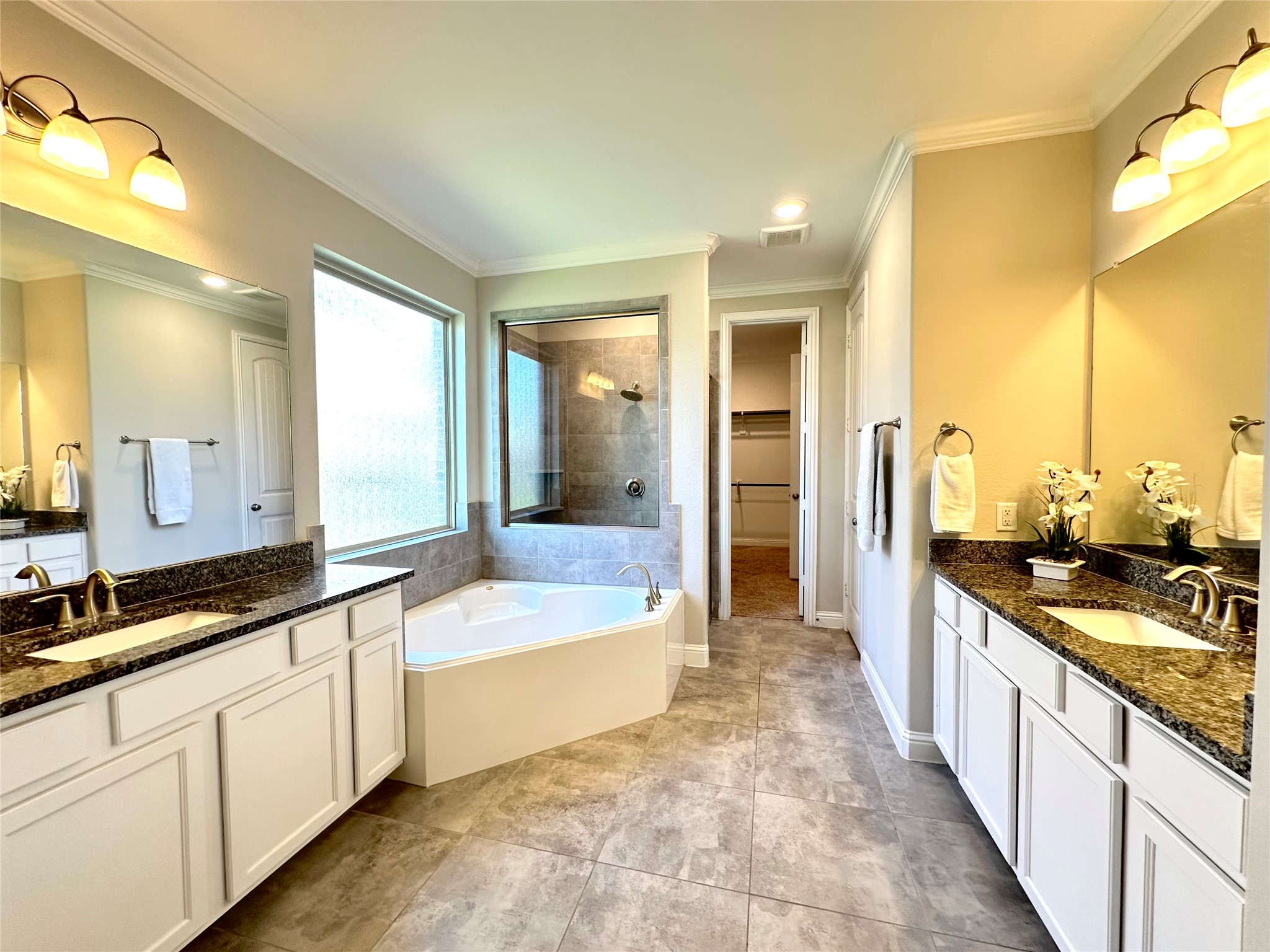 Primary bathroom with double sinks and elegant separated shower from bath tub.