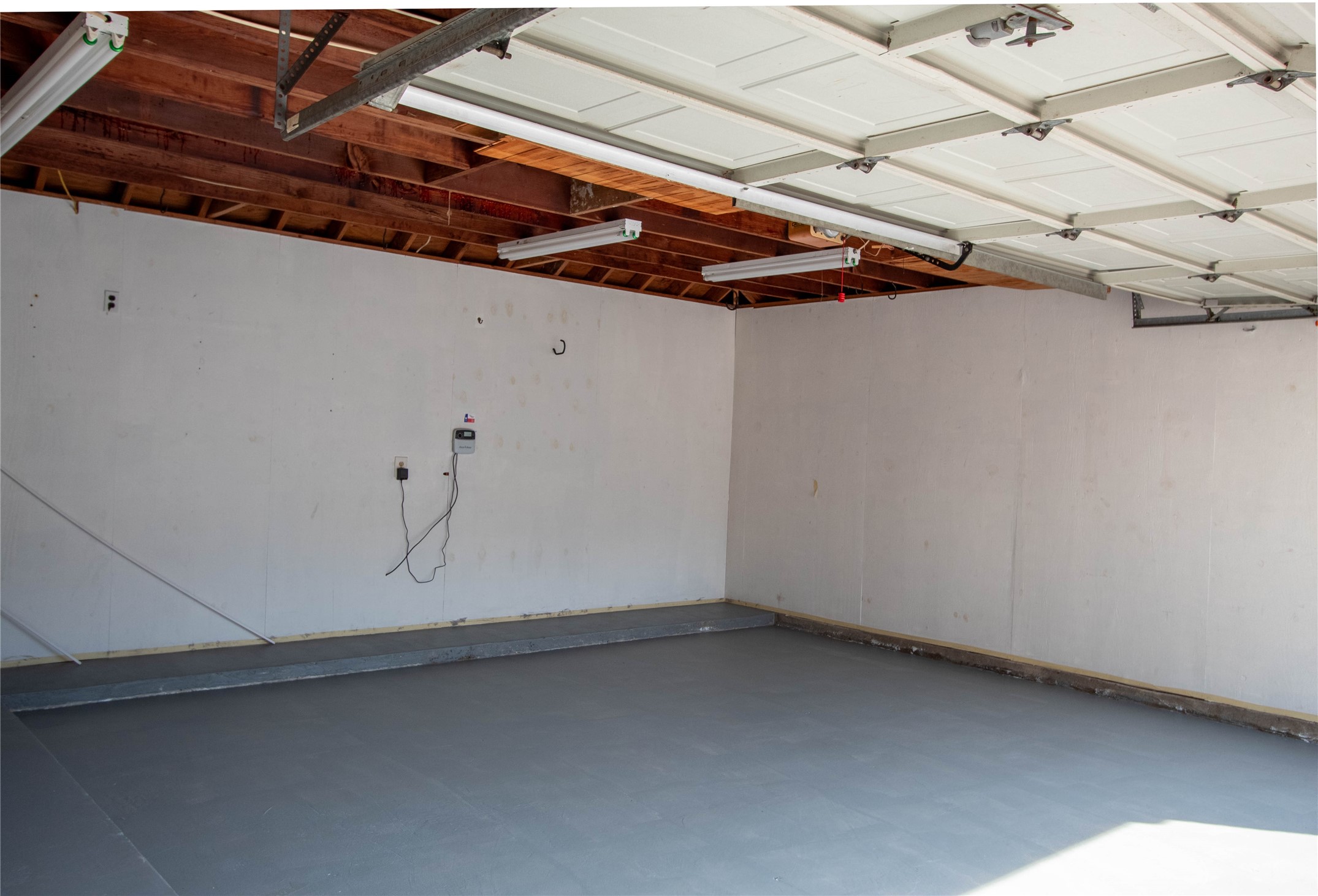 The sprinkler system control is in the garage and has an automatic setting.