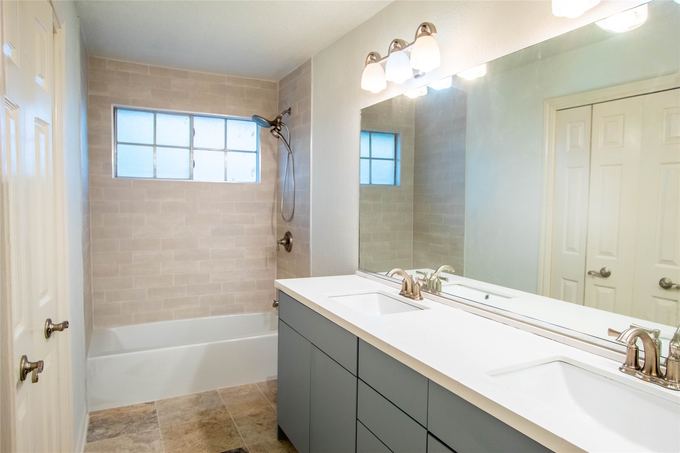 Second floor bathroom newly updated, new shower from tile to tub. tile flooring, and double sink quartz countertops.