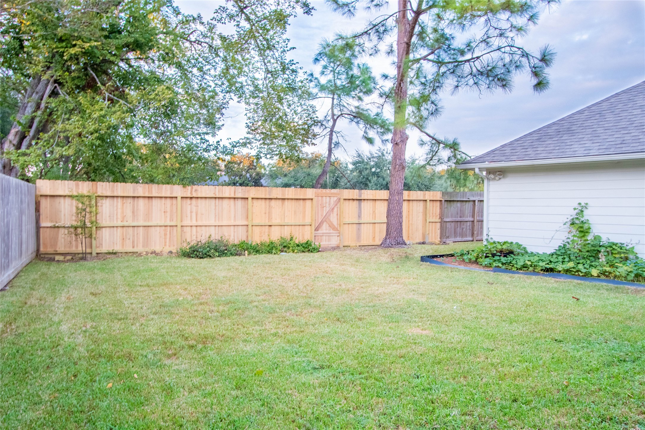 The backyard green space is large enough for a pool, or a playground. New back fence.