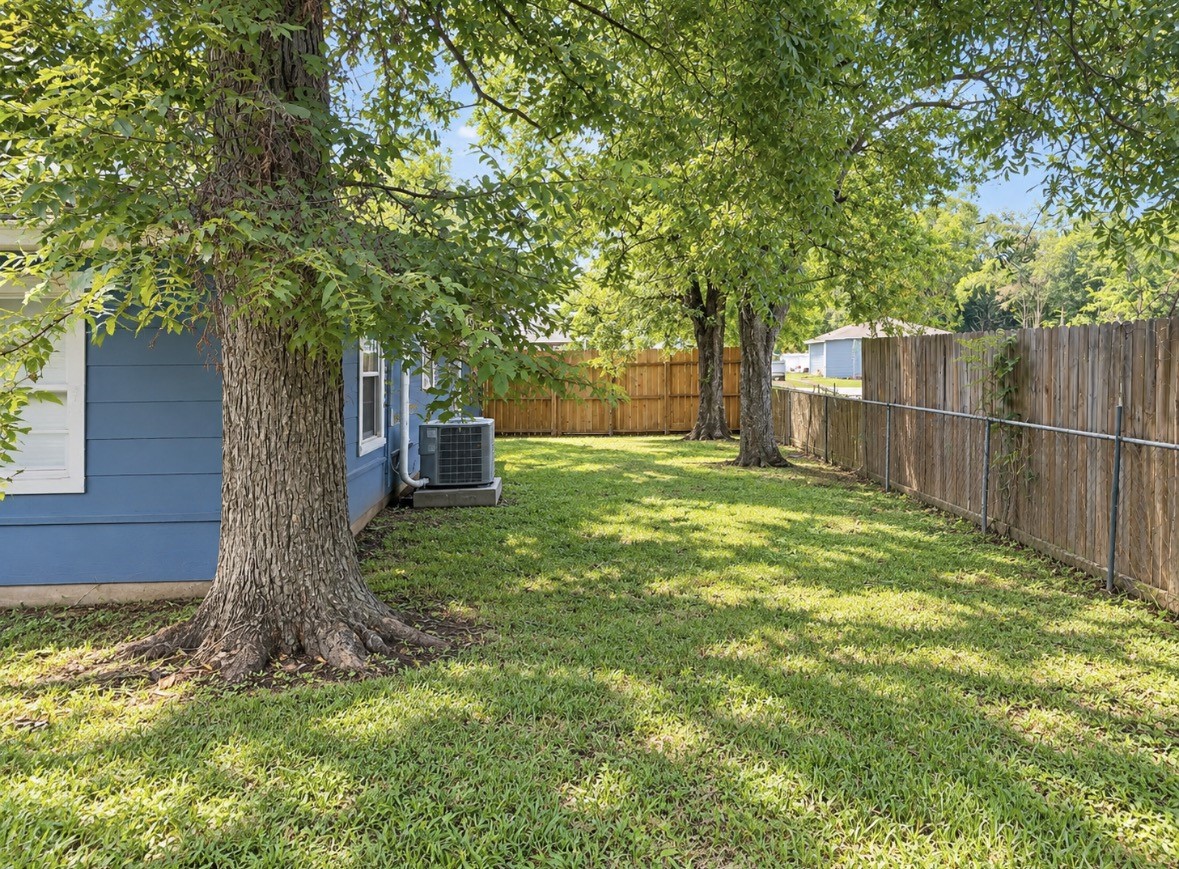 Step out back to a shady yard with mature trees and room to enjoy the outdoors