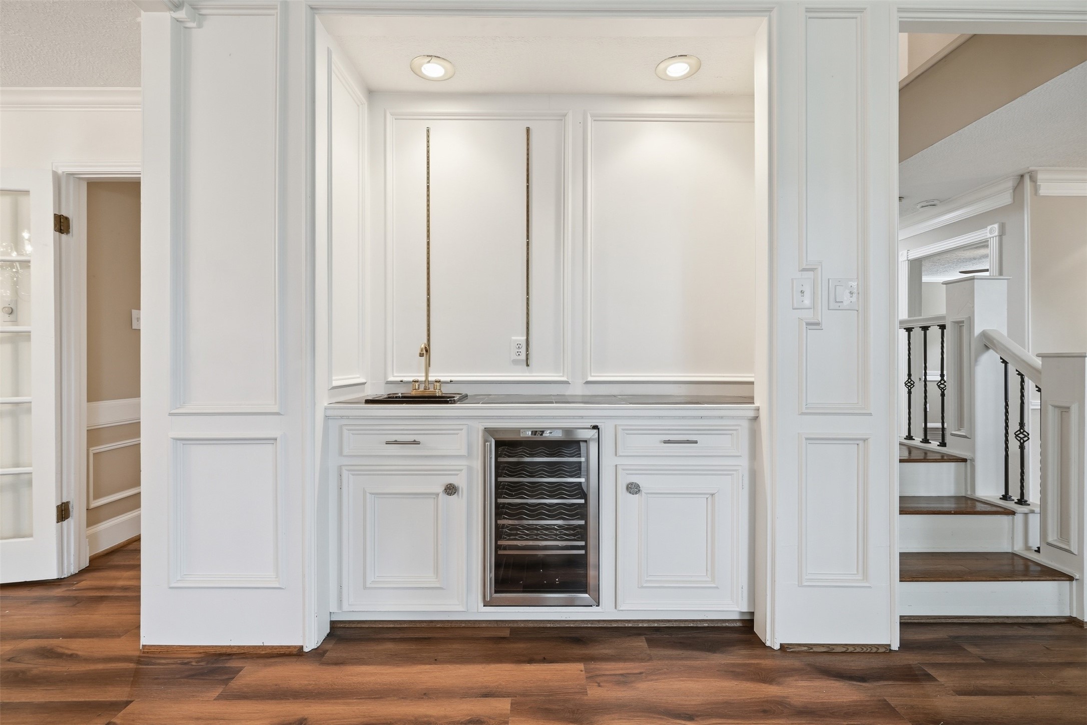 Entertain with ease at the built-in wet bar featuring a wine refrigerator, sink, and additional storage-perfect for hosting guests.