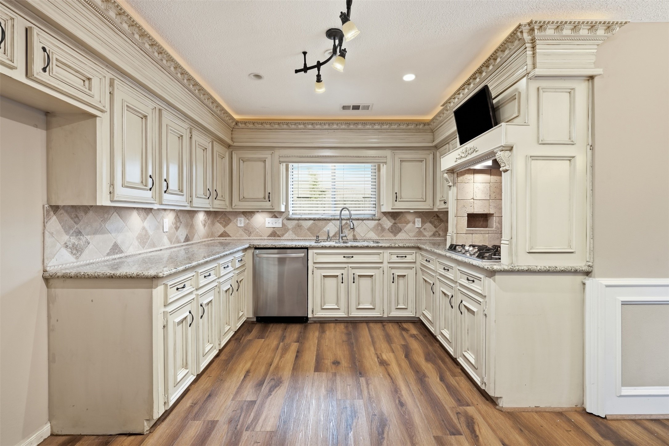 The beautifully appointed kitchen offers abundant cabinetry, generous countertop space, and a layout designed for both everyday cooking and entertaining.
