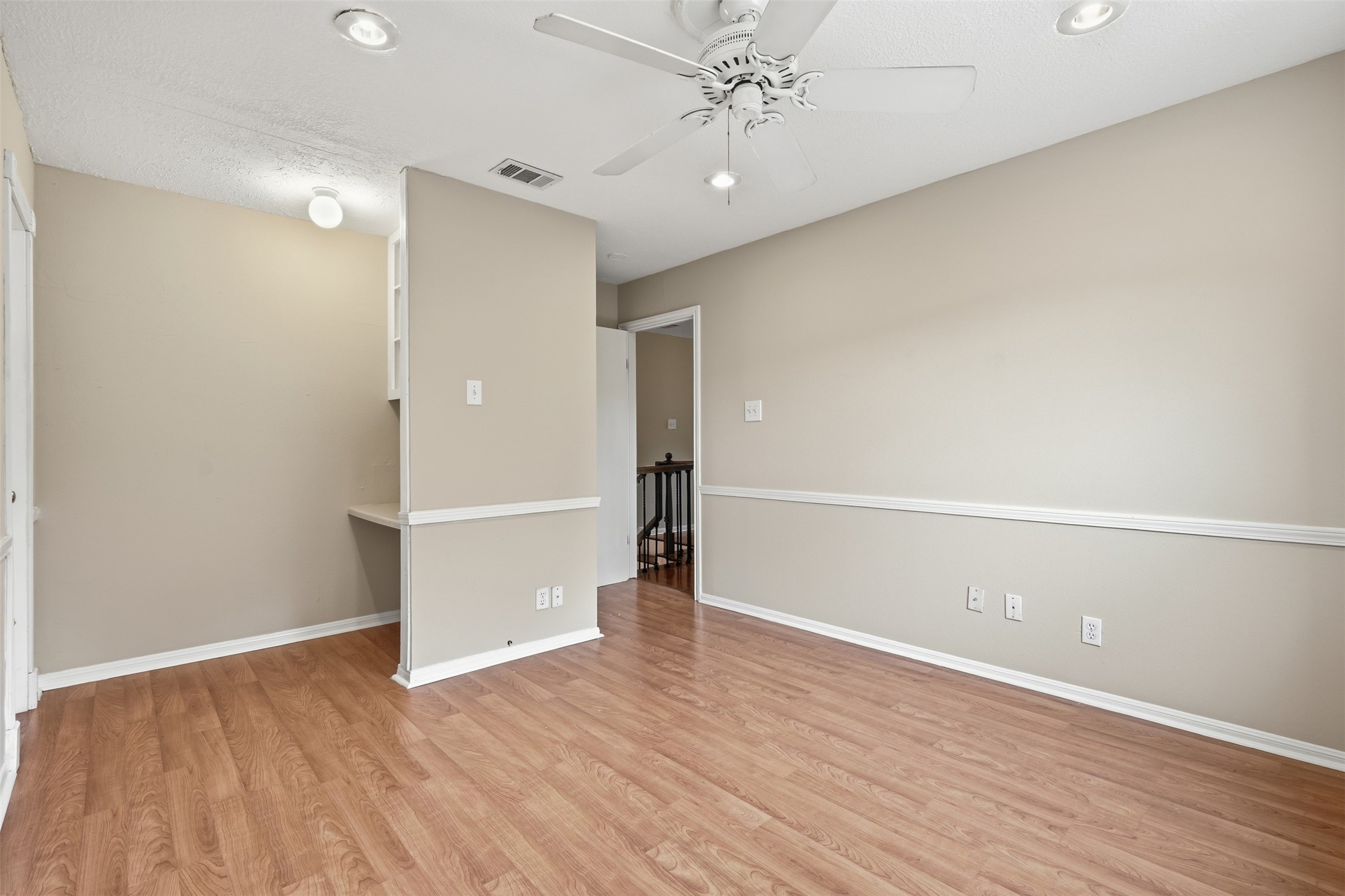 Bright and inviting secondary bedroom with generous proportions and convenient access to nearby bathrooms.