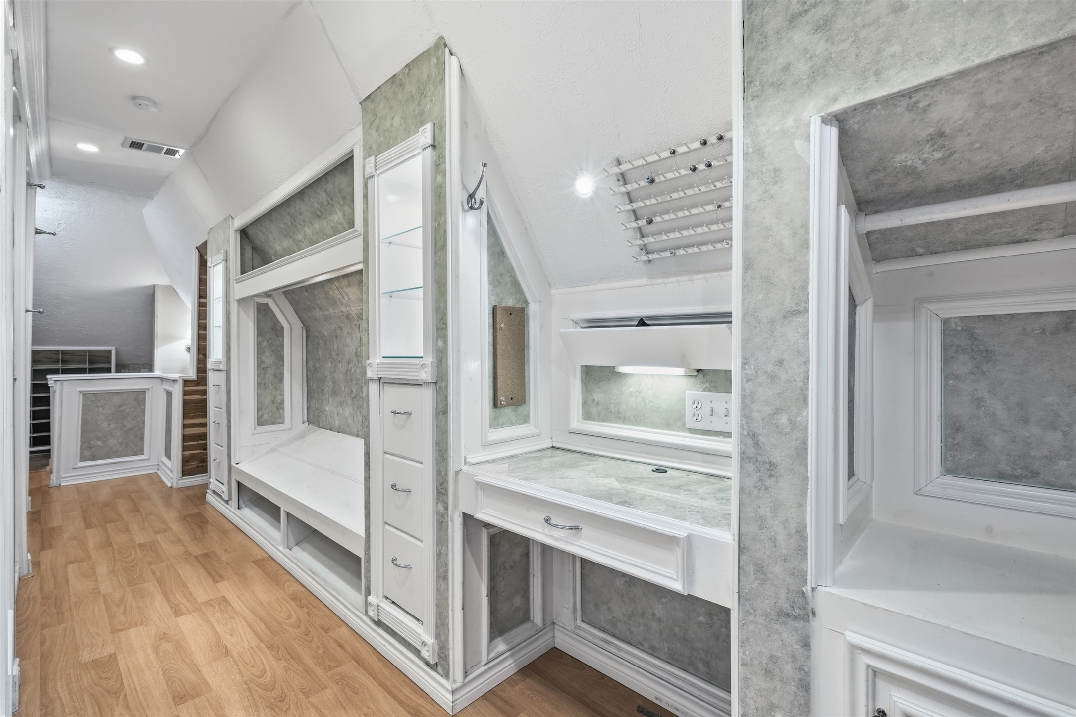 Rarely found, the upstairs primary closet offers a dedicated dressing area with remarkable storage capacity.