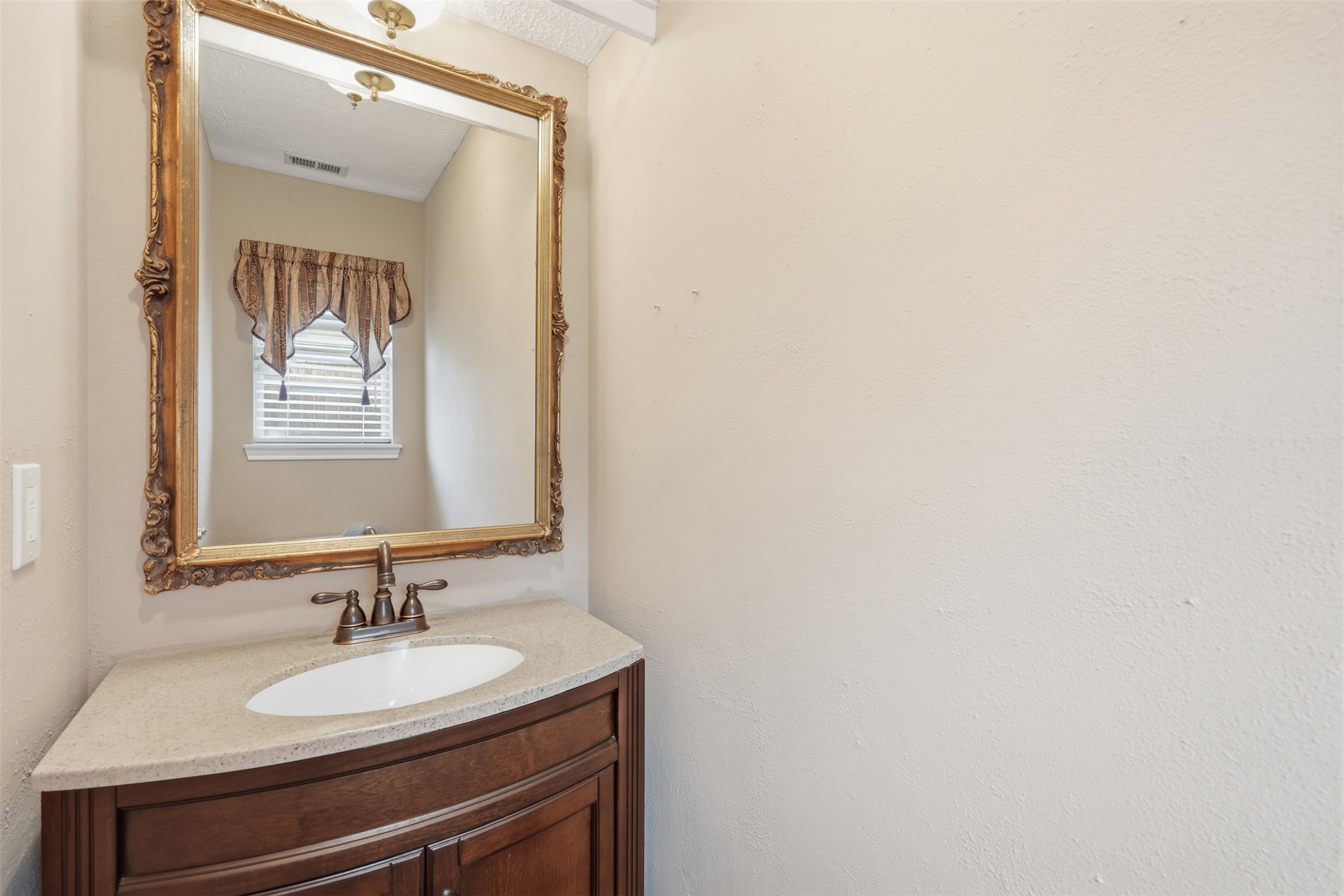Conveniently located powder bath offers comfort and convenience for guests.