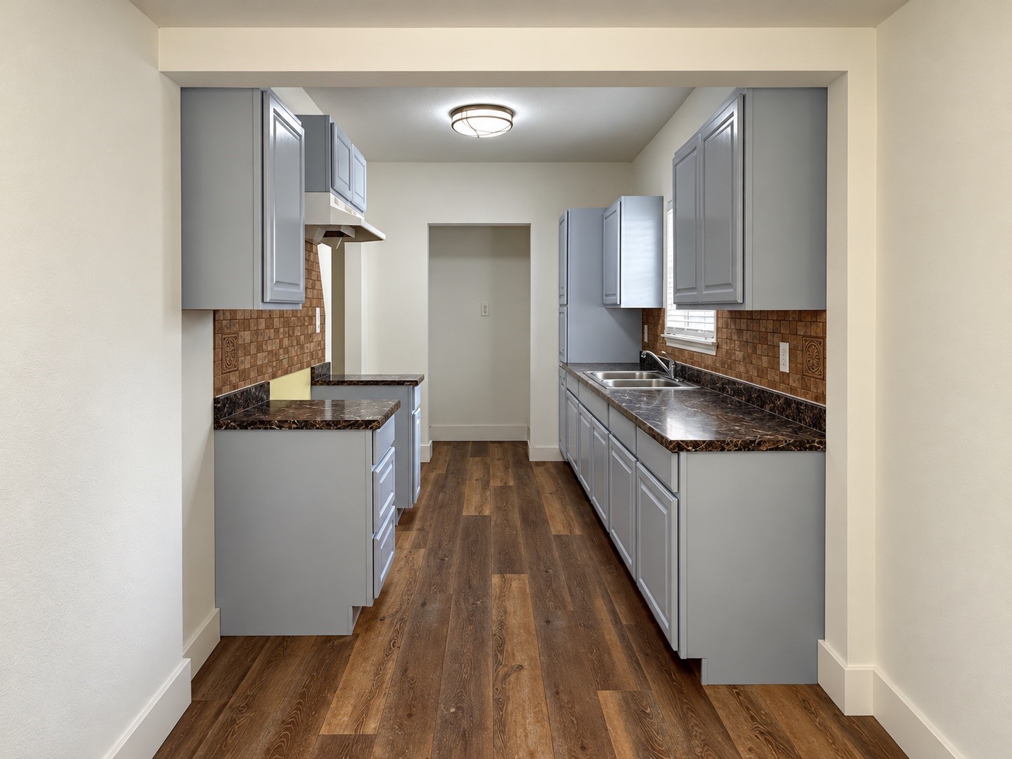 Streamlined kitchen with beautiful counters and cabinetry