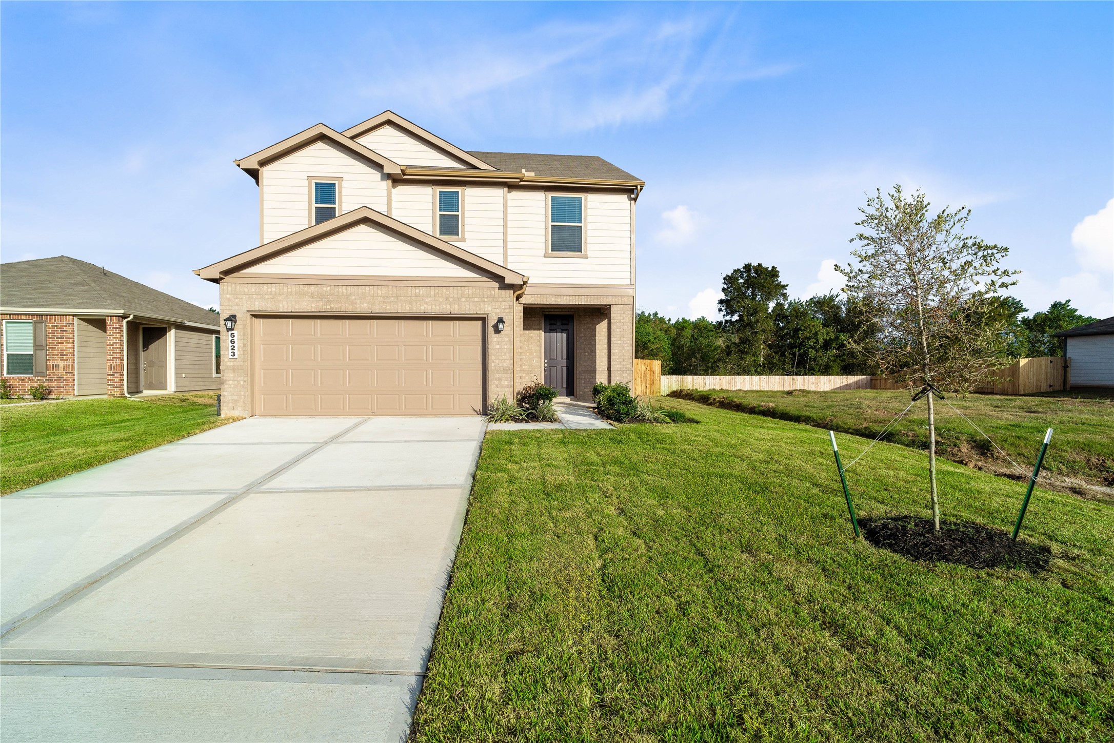 Welcome to 5623 Blackbird Lane in Sunset Grove, featuring a fresh KB Home exterior with warm beige siding, contrasting dark green shutters, and a welcoming covered entry. Ready to see all this new construction home has to offer? Schedule your private showing today!