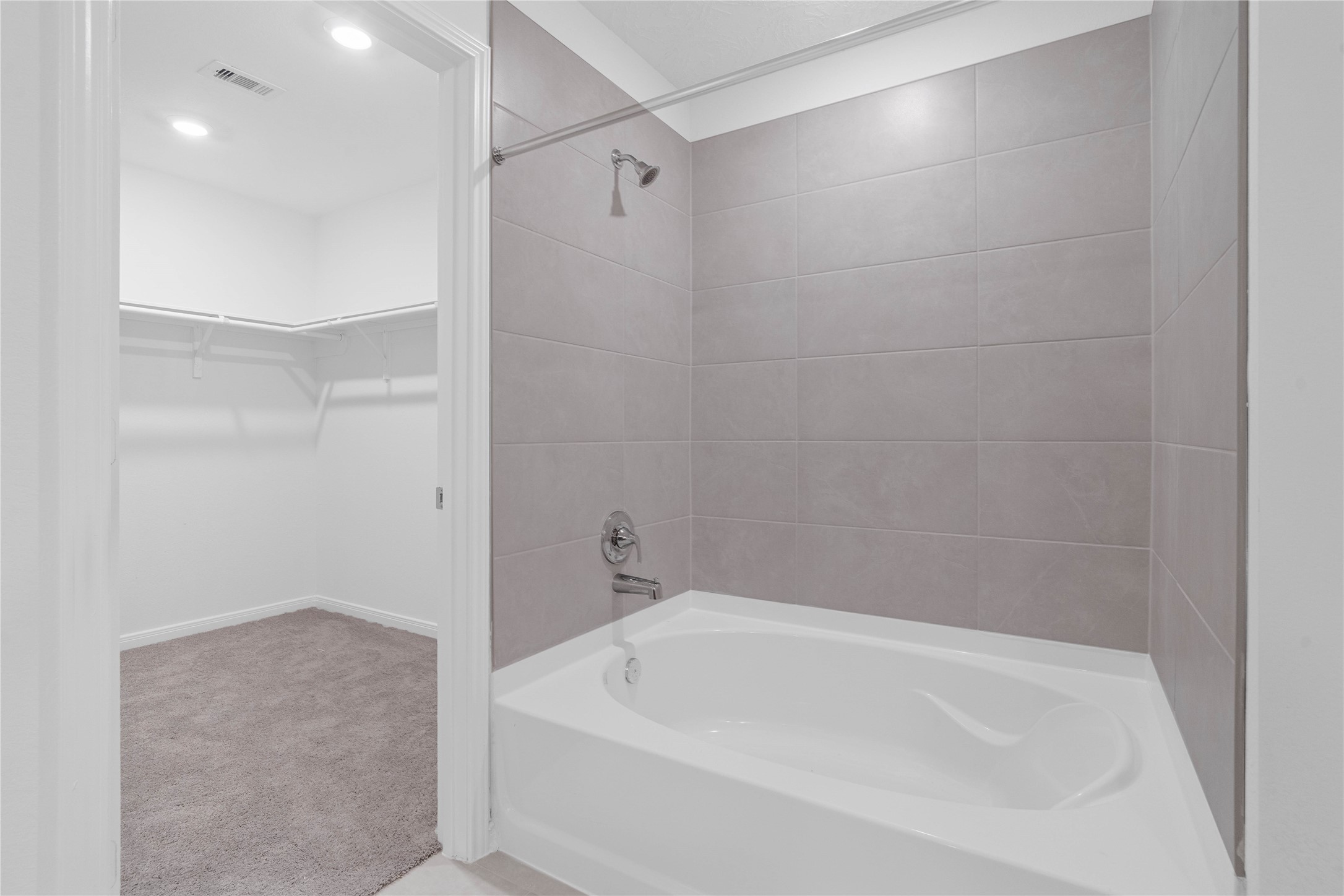 Designed with everyday comfort in mind, the primary bath includes a dual sink vanity and a tub and shower combination with elegant light tile. The understated finishes create a bright, practical space to start and end your day.