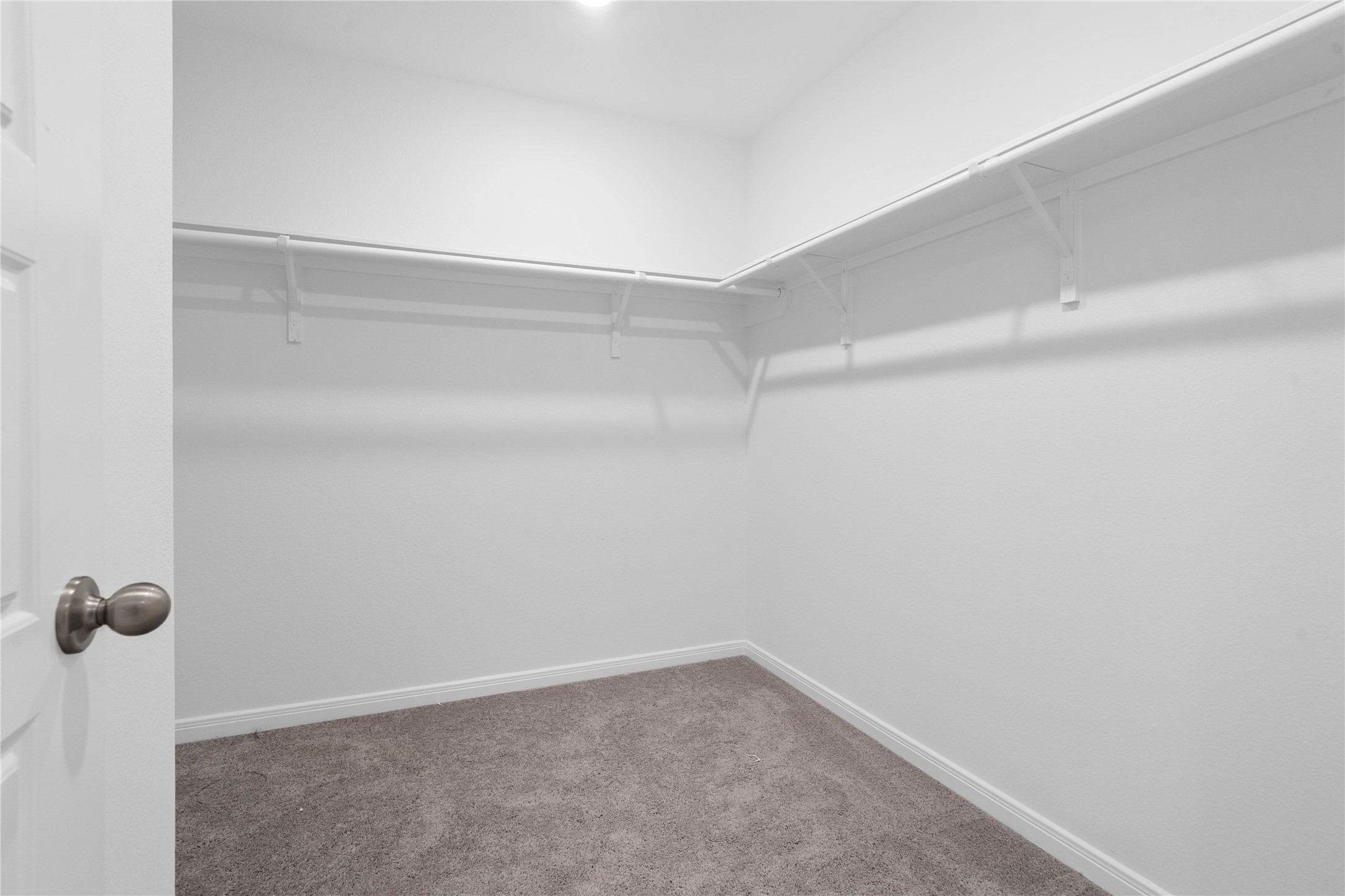 The primary walk in closet provides convenient storage for clothing, shoes, and everyday essentials, helping keep your personal space organized.