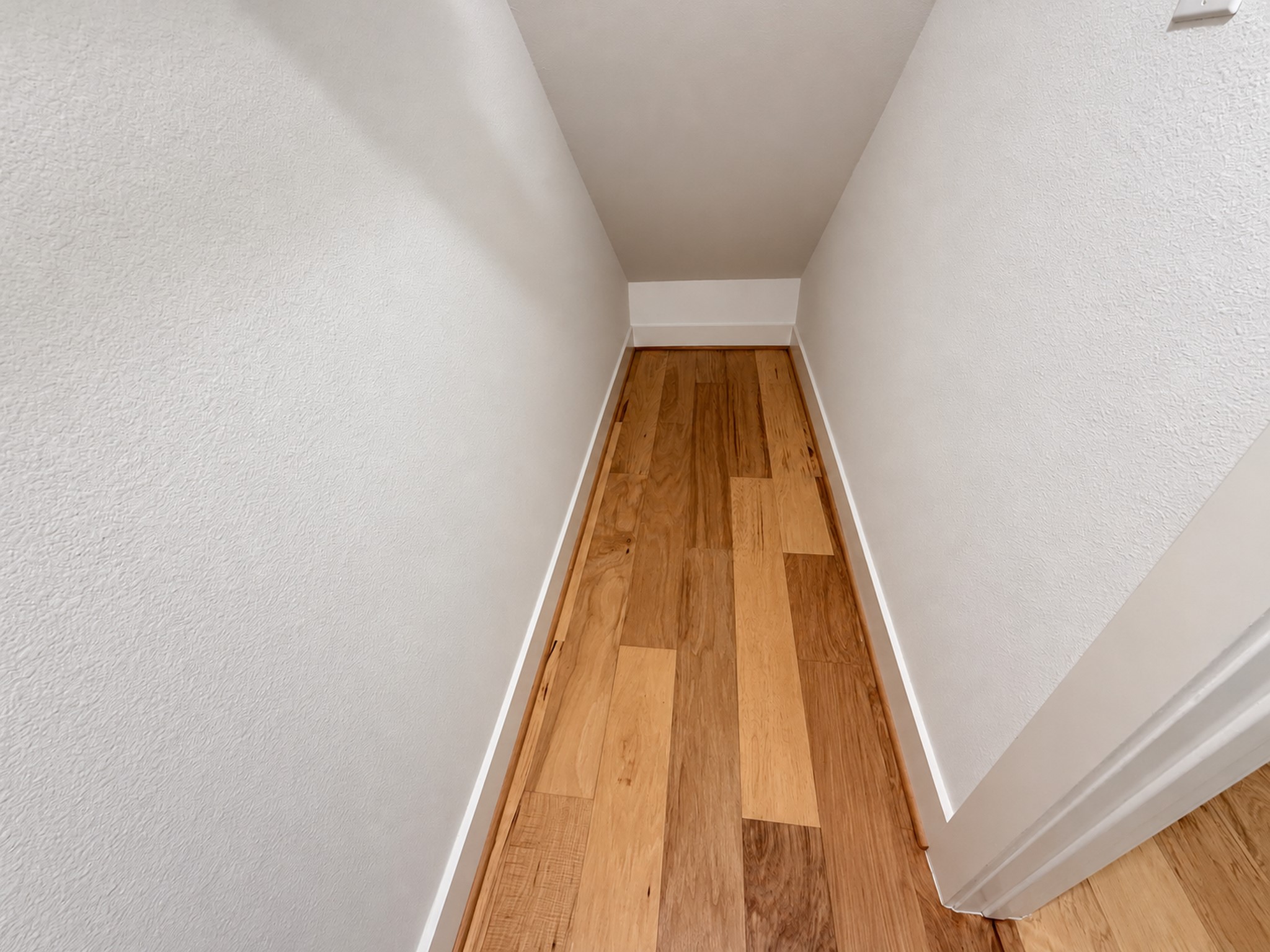 Convenient first-floor storage room tucked beneath the stairs.