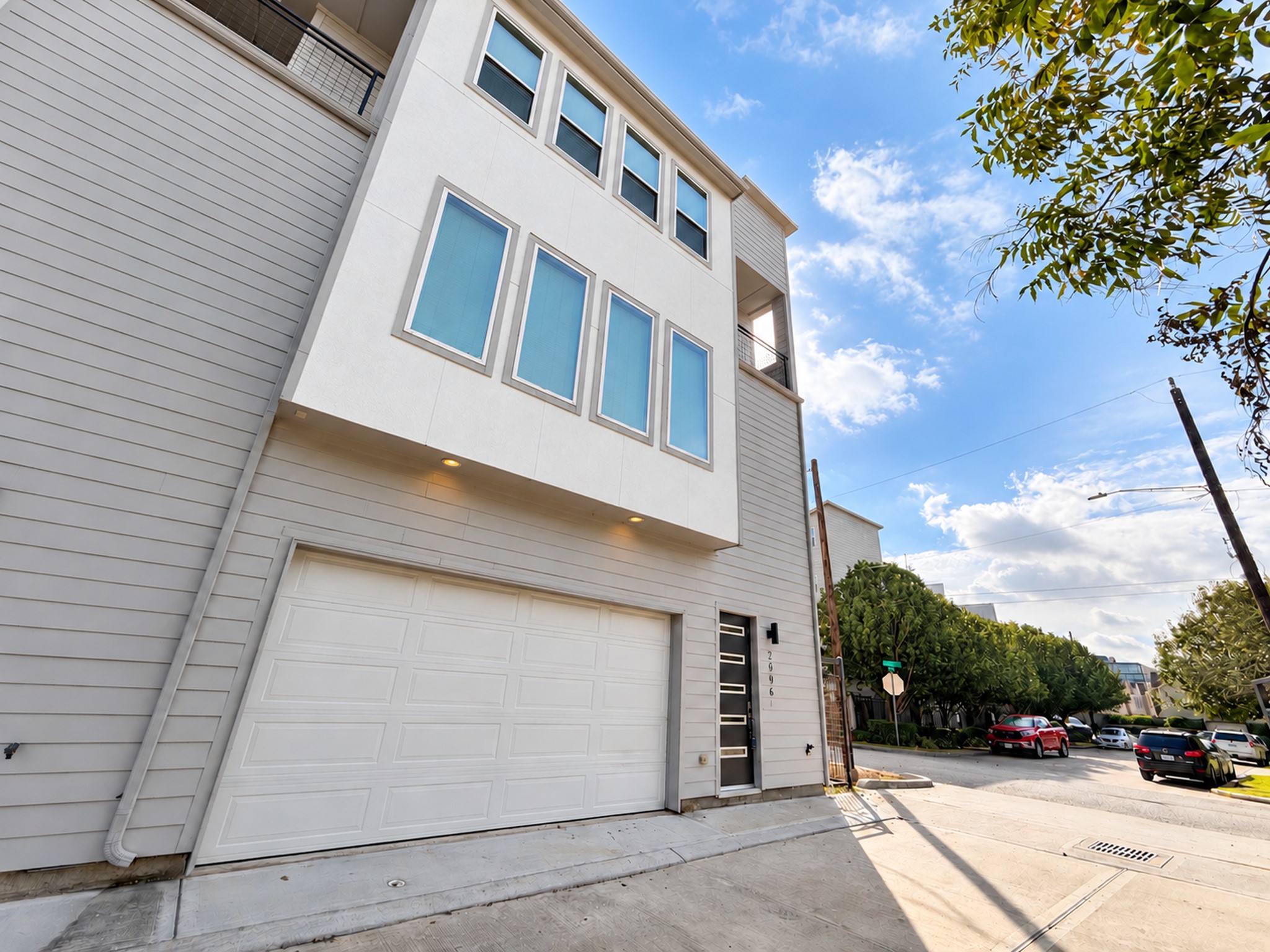 A modern three-story corner townhome with abundant windows that fill the interior with natural light.