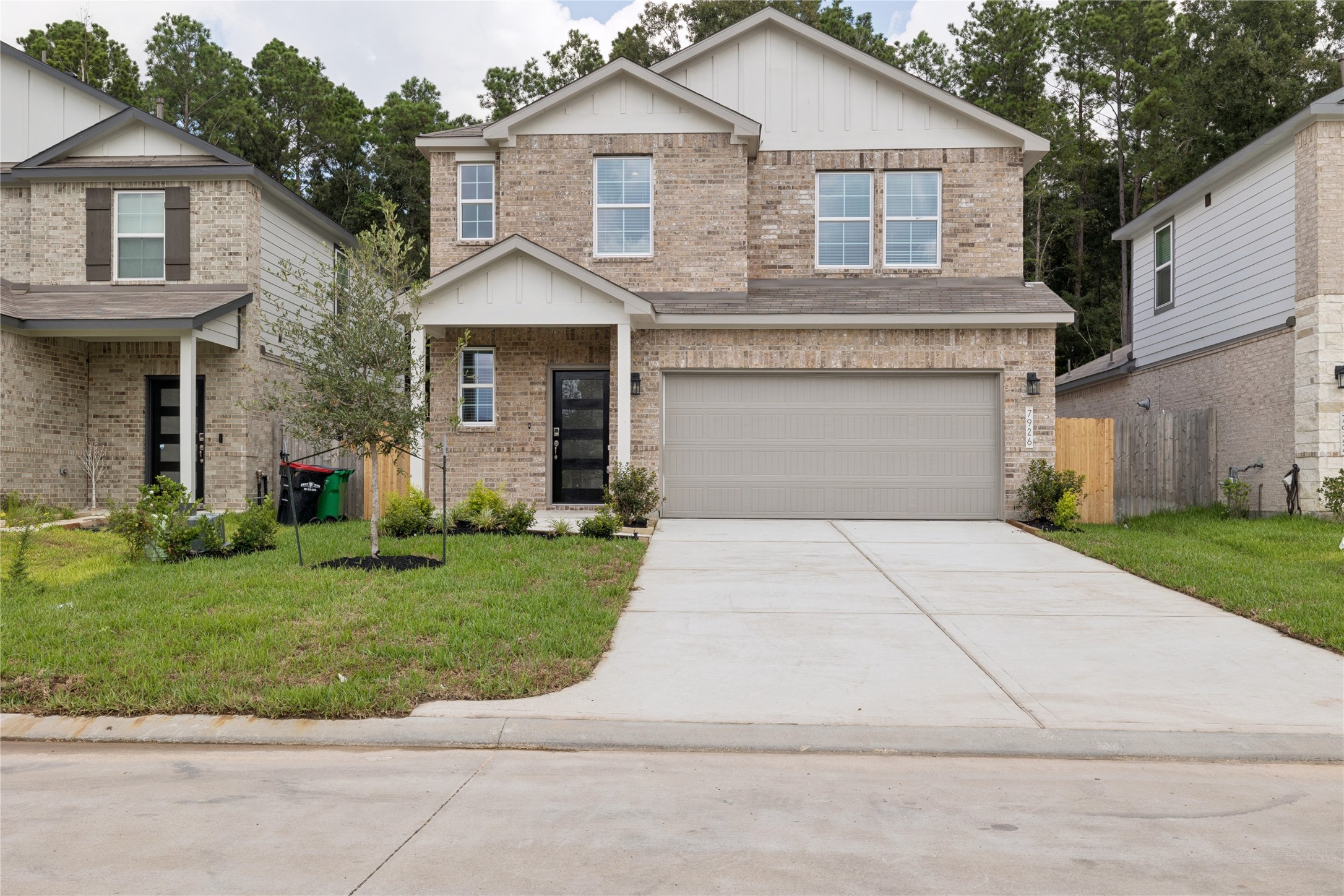 Charming two-story brick home with a double garage and inviting front entrance, nestled in a quiet neighborhood with lush greenery. Charming two-story brick home with a double garage and inviting front entrance, nestled in a quiet neighborhood with lush greenery.