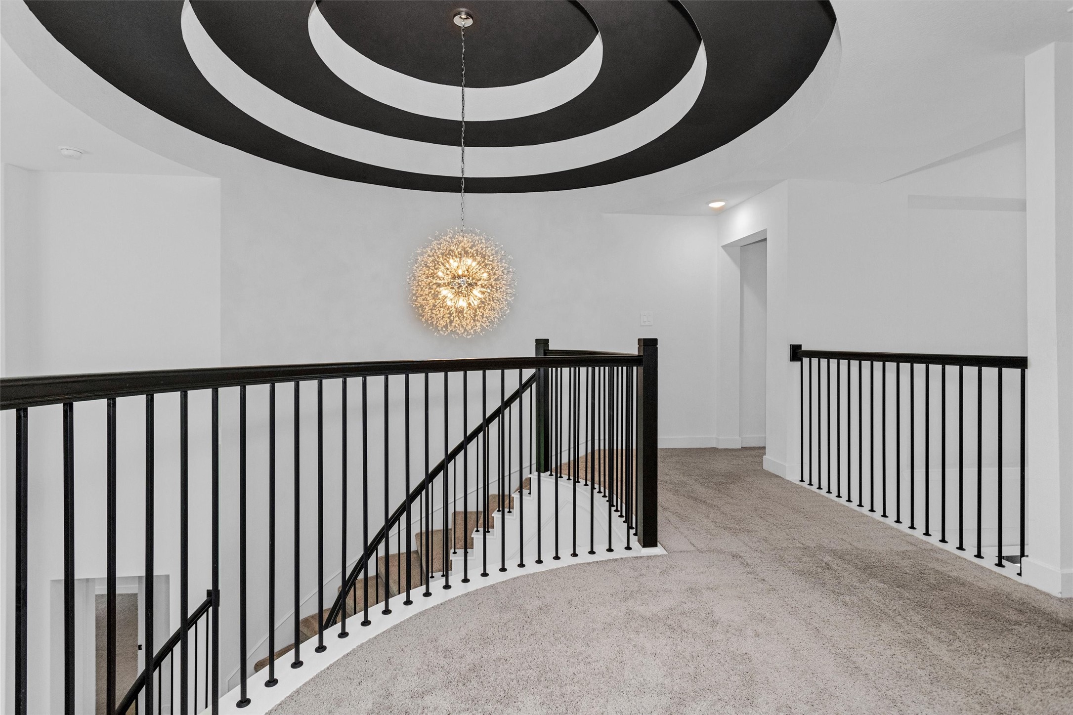 Custom ceiling details and an exquisite chandelier continue the homes elevated sense of luxury, adding sophistication, warmth, and designer elegance throughout.