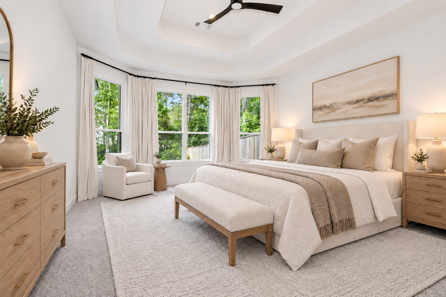 Private primary bedroom perfectly positioned with windows overlooking nature from both the side and back of the home, creating a peaceful retreat filled with serene wooded views and natural beauty.