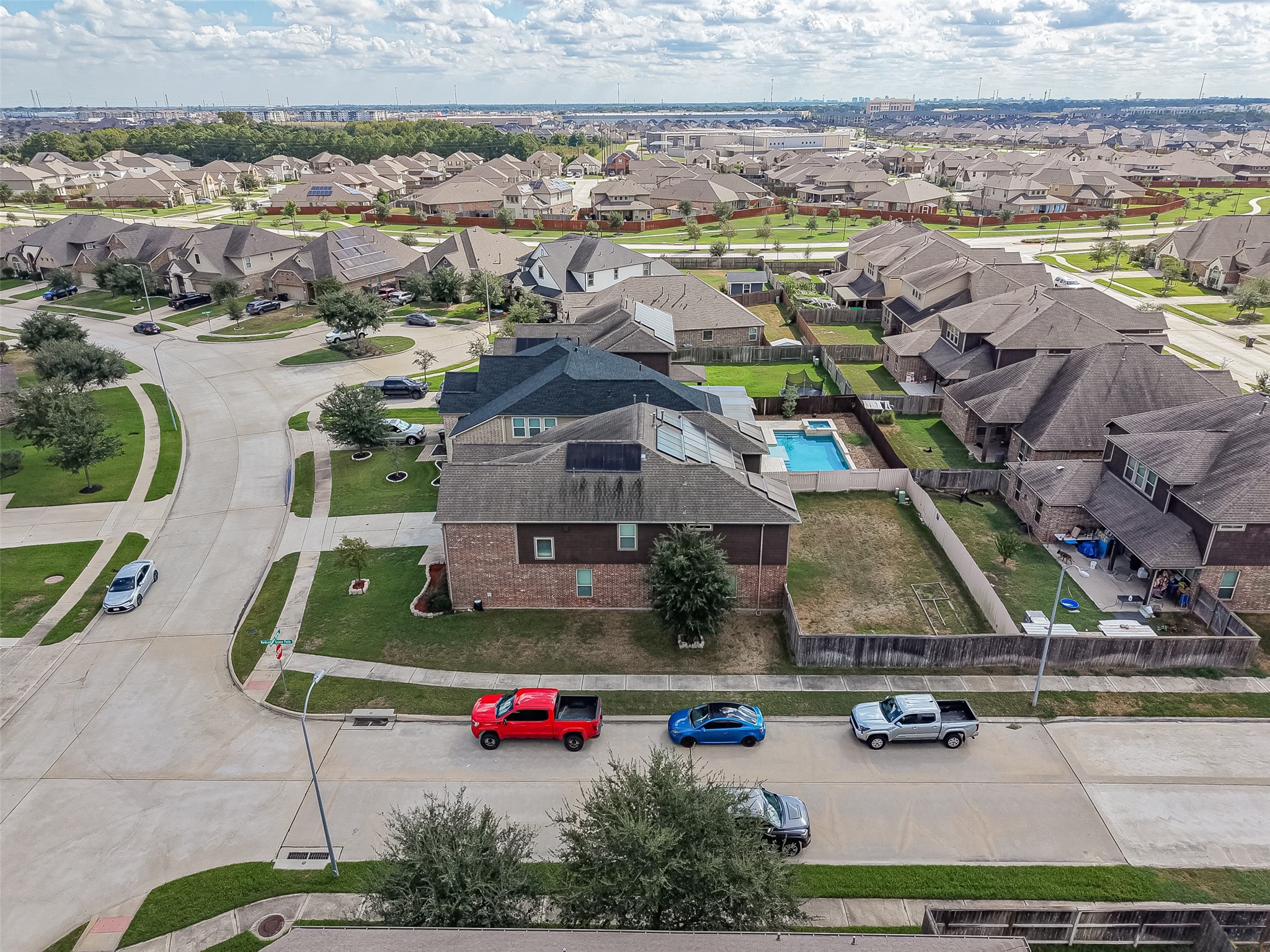Spacious suburban neighborhood with well-maintained homes, featuring a property with a sizable backyard and private pool, perfect for family living.
