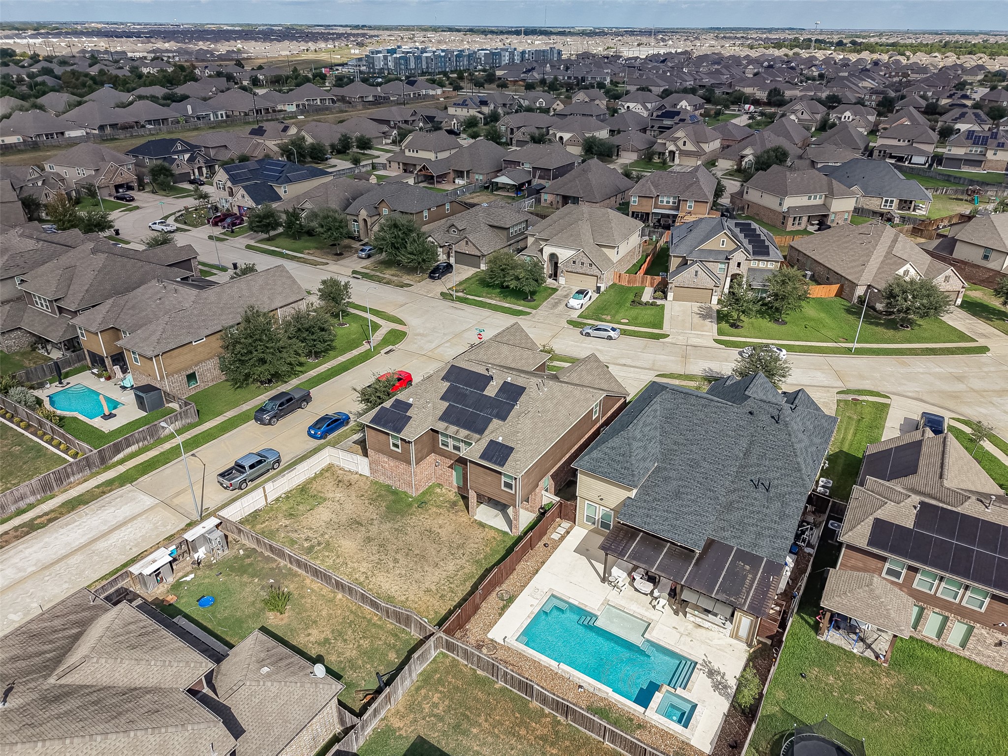 Nestled in a vibrant neighborhood, this home boasts a spacious backyard with a sparkling pool, perfect for relaxation and entertaining. Solar panels enhance energy efficiency, while the surrounding community offers a serene suburban atmosphere.