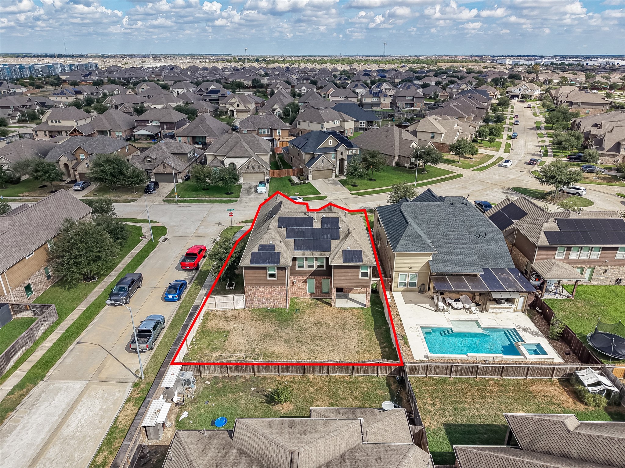 Spacious two-story home with solar panels, situated in a vibrant neighborhood, featuring a generous backyard for outdoor activities.