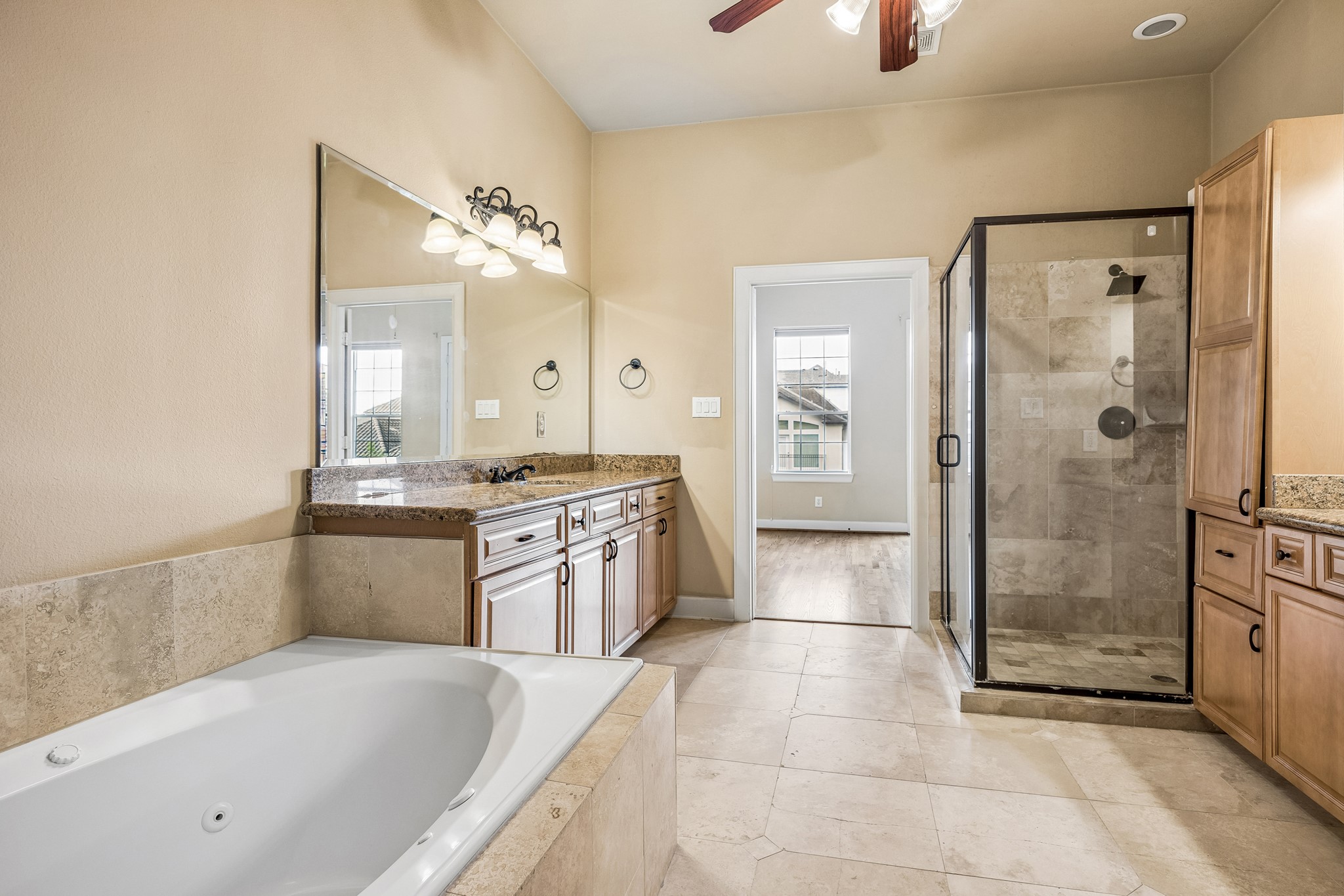 Primary bath with shower, soaking tub and two sink areas.