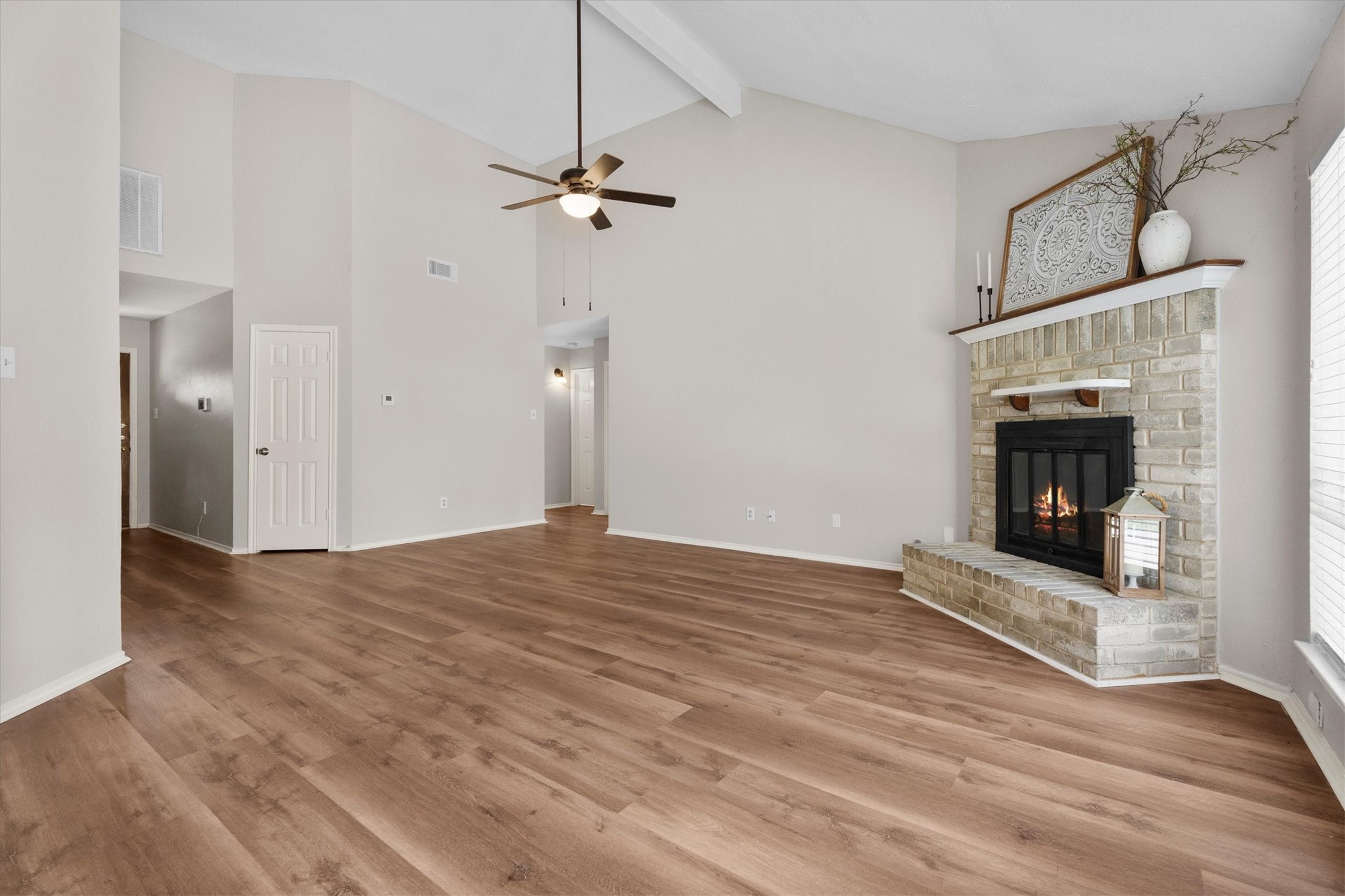 Open view of the living area highlighting the rooms flexible layout and connection to the entryway.