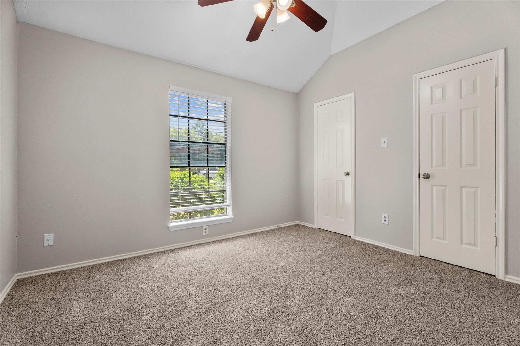 Another secondary bedroom features generous closet space and a ceiling fan.