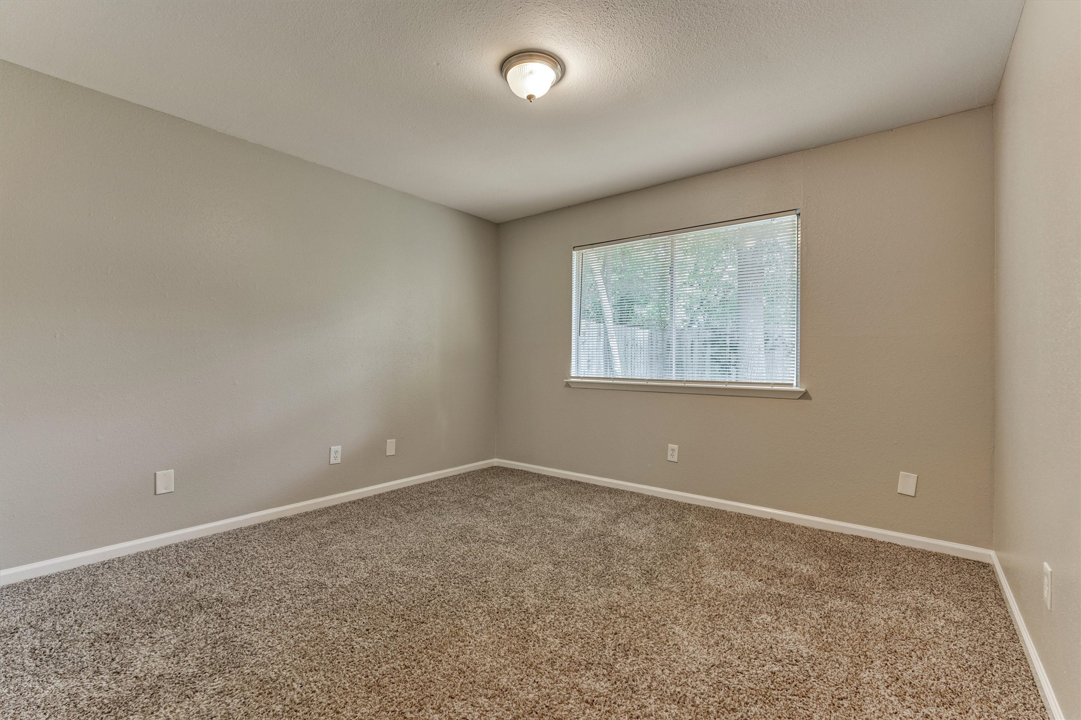 This secondary bedroom is also located on the back of the home.