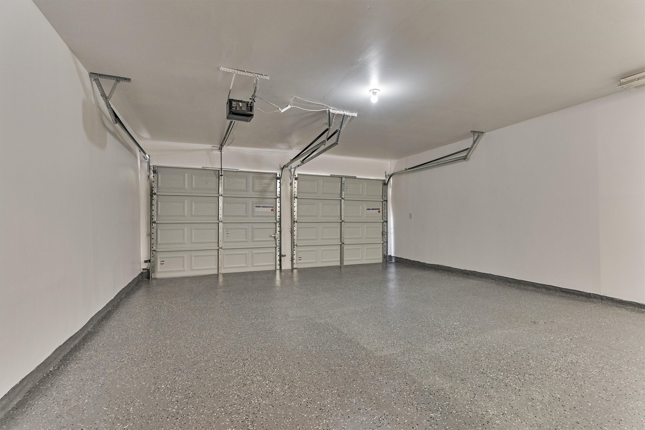 The garage has been freshly painted and epoxy flooring applied.  Brand new garage doors too!