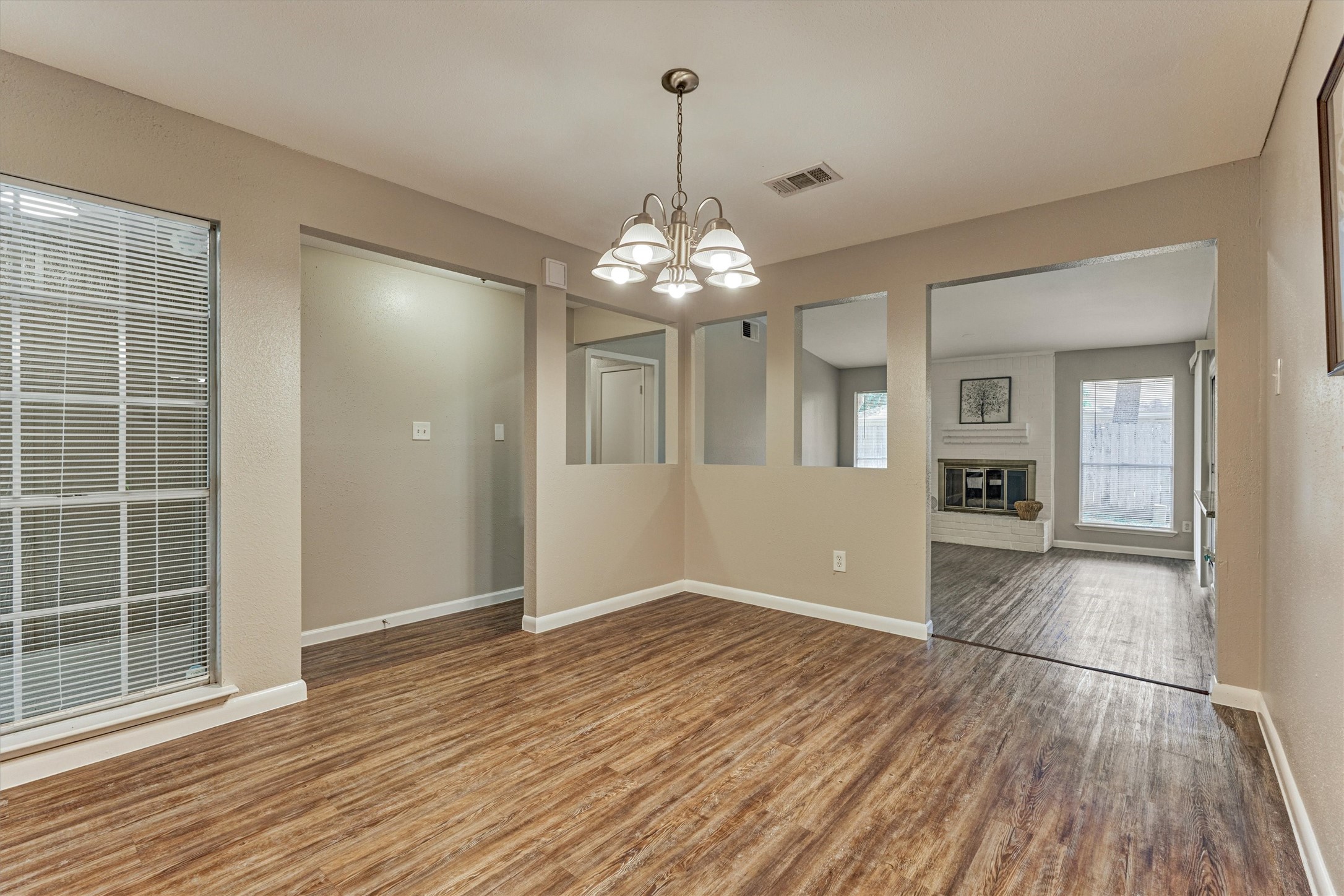This view highlights the open concept within the living areas.  Updated light fixtures are throughout the home.
