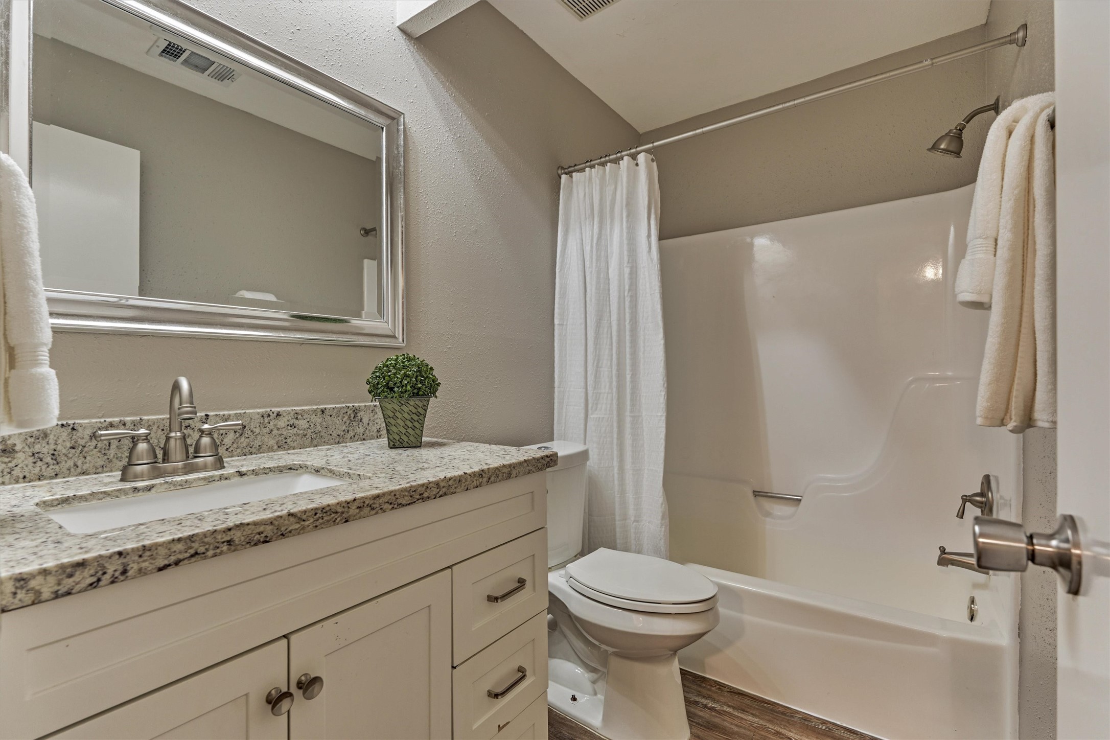 The secondary bathroom has a newer vanity with granite and updated fixtures.