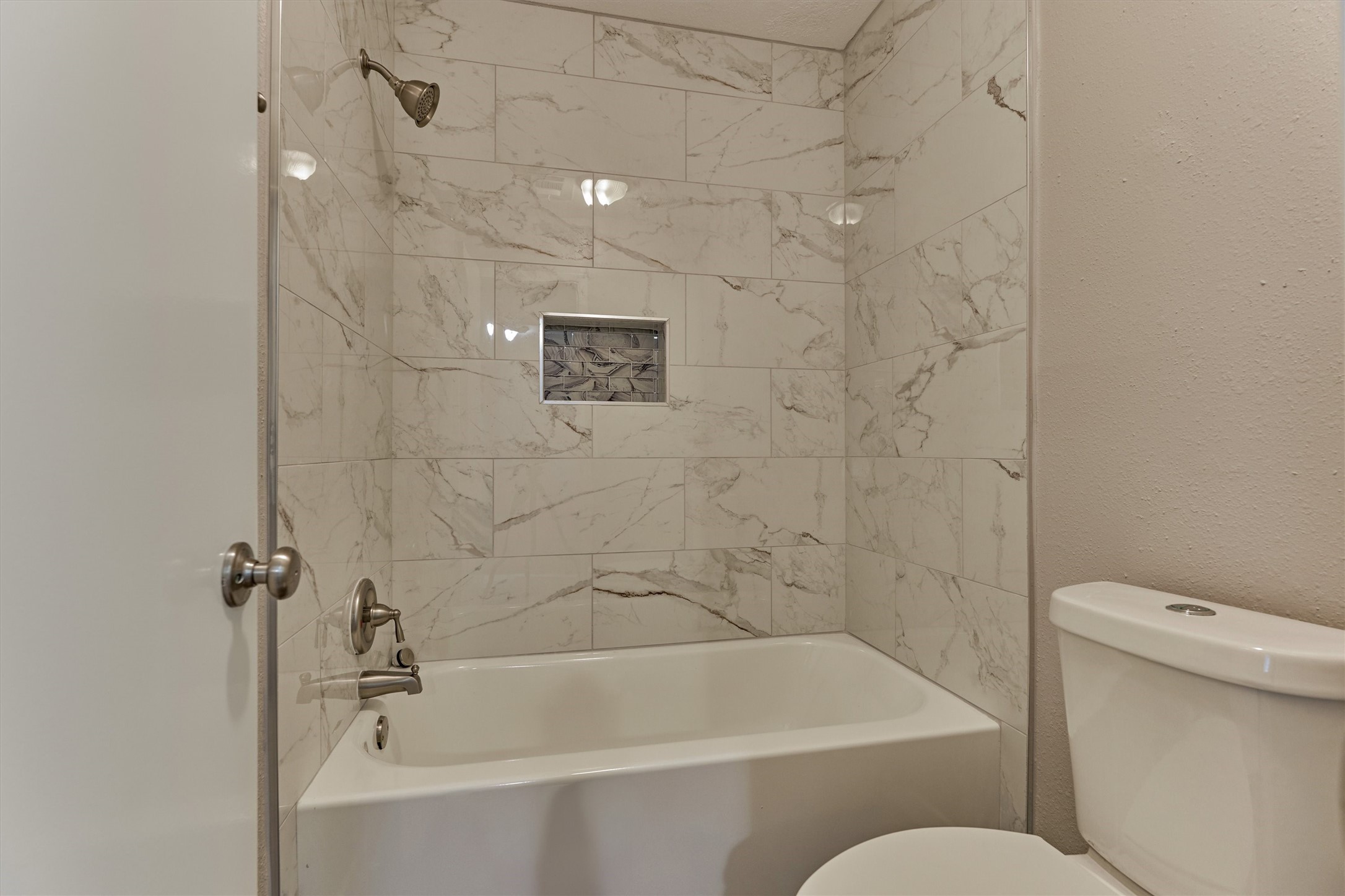 A brand new update to the primary bathroom is the decorator tile shower surround and tub.